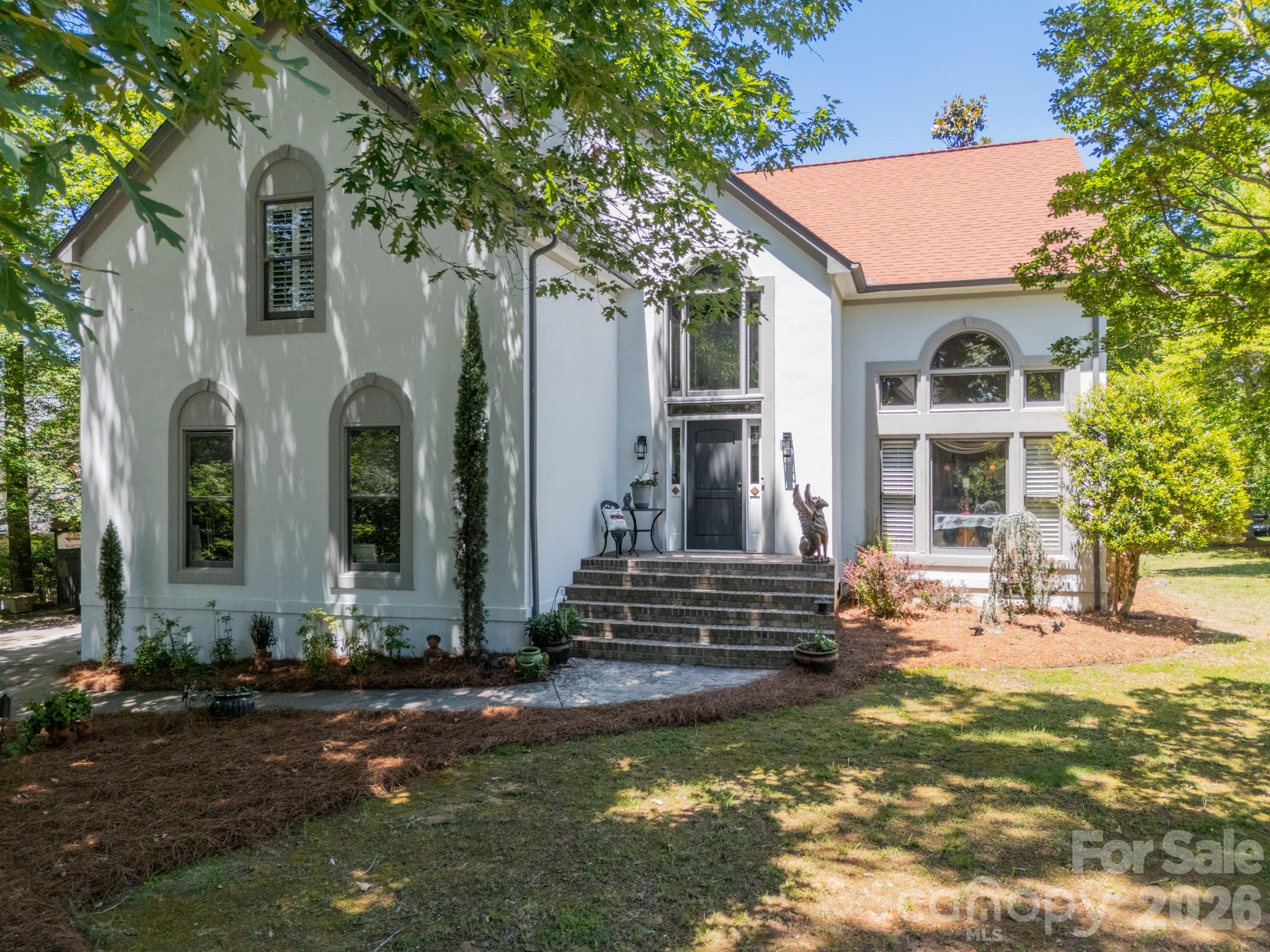 Tons of character in this beautifully updated home in sought after Seven Coves of Tega Cay. Beautiful bright home that flows well with a nice open concept feel that still offers separate living areas. Hard to find, huge flat yard with secluded deck! Hardwoods and tile throughout (carpet in 2 bedrooms), and newly renovated kitchen with quartz countertops and backsplash. Owners retreat on main level with gorgeous remodeled bathroom. Perfect home for entertaining & outdoor living! 
Main floor: 2 story living room, Office/dining room, updated kitchen with Calcutta quartz counters, huge peninsula, walk-in pantry, & stainless appliances. Great Room with vaulted ceilings and gas fireplace, breakfast area, primary bedroom with French doors to the deck, updated primary bathroom, guest bathroom, laundry, & oversized 2 car garage with storage above.  Tons of storage throughout including multiple closets & large walkable attic. Upstairs:  Three bedrooms with large closets, beautifully remodeled bathroom, & huge media/bonus room.  Highly rated Fort Mill Schools. Tega Cay is a recreational city on the shores of Lake Wylie with so much to offer! Take advantage of the lifestyle Tega Cay offers with social events, golf, tennis, pickleball, swim club, waterfront parks, walking trails, and Lake Life activities easily accessible. All this with NO HOA!
