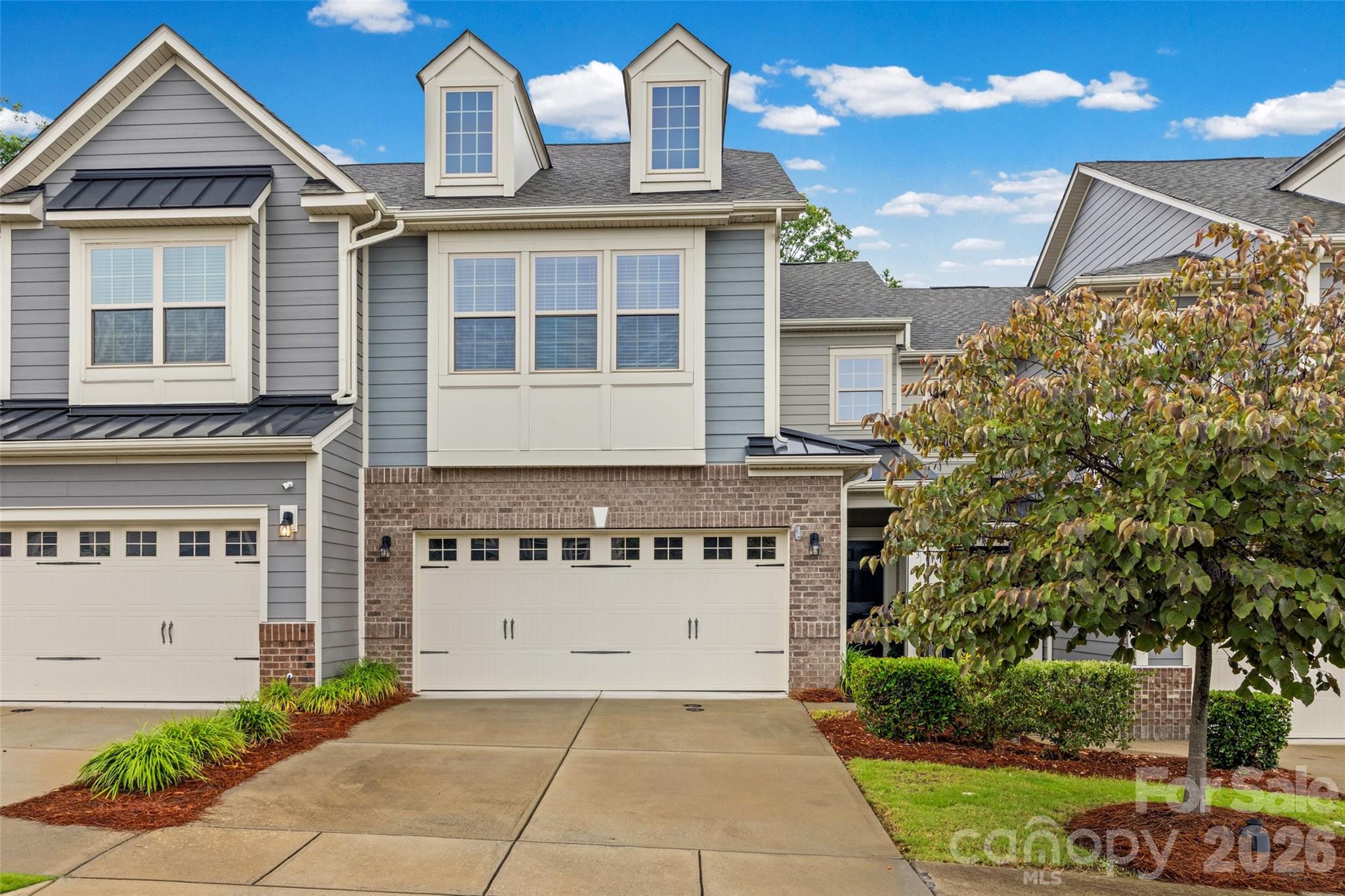 Welcome home to this beautifully maintained townhome in Cameron Creek featuring a charming covered front porch and an open-concept floor plan designed for comfortable living and entertaining. Crown molding throughout main floor  The spacious kitchen showcases a large granite island, granite countertops, stylish tile backsplash, gas range, elegant pendant lighting, and an oversized walk-in pantry. The adjoining dining area has an upgradedesigner crystal chandelier by Hudson Valley and flows seamlessly into the family room, complete with a stone-surround electric fireplace. Durable laminate flooring throughout the main provides convenience and style. Upstairs, the light-filled primary suite offers abundant natural light from large windows, a spacious walk-in closet, and a luxurious en-suite bath featuring dual vanities and an oversized walk-in shower with a built-in seat. Two additional generously sized bedrooms with ample closet space, a convenient upstairs laundry room, and neutral paint throughout complete the second level. Step outside to the private rear patio, where you can relax while enjoying peaceful views of the natural common area behind the home. Enjoy all that Cameron Creek has to offer including a large community pool with kids’ splash zone pool, playground, outdoor fireplace, and neighborhood activities that create a true sense of community. Ideally located in the heart of Tega Cay, this home offers easy access steps away to shopping, restaurants, Lake Wylie, Fort Mill, Steel Creek, and I-77, making commuting and everyday conveniences just minutes away. Come make this beautiful townhome yours!