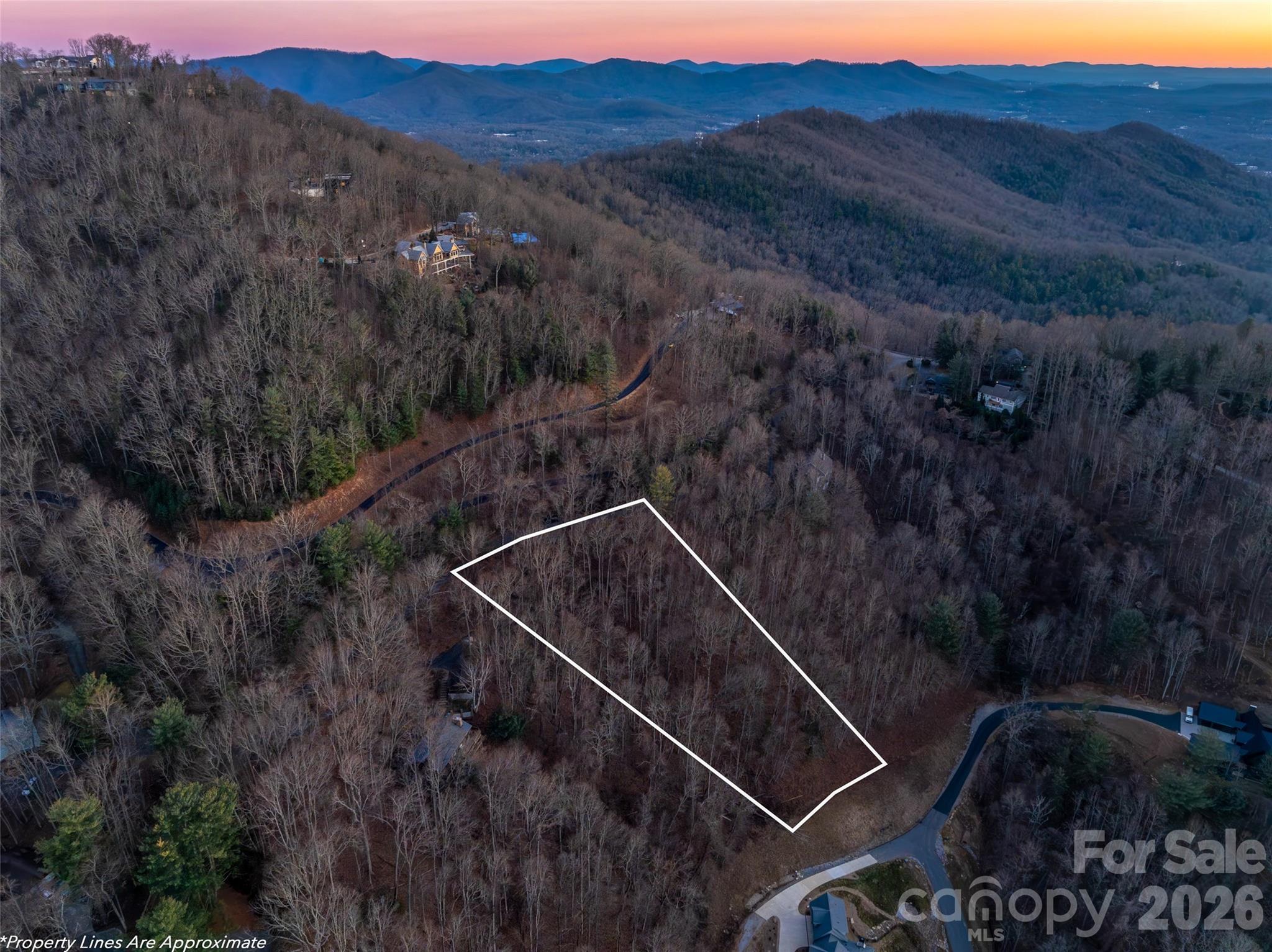 Welcome to 34 Mountain Vista Drive. This lot presents a rare opportunity to own 1.12 acres just off the esteemed Town Mountain Road, approximately 7 minutes from downtown Asheville. This building lot features sweeping, long-range western views across the French Broad River valley and onward to the layered peaks of Pisgah National Forest—an ideal setting for a custom mountain retreat. Located just outside AVL city limits, this lot offers exceptional flexibility, including the potential for a short-term rental investment in a highly desirable location. Mountain View Estates has no HOA, no architectural review, and no minimum square footage requirements (buyer to confirm), allowing the freedom to design the home of your dreams. Well-suited for a second-home owner seeking privacy, views, and proximity to downtown amenities, or an investor looking for long- or short-term rental potential. This versatile lot delivers location, scenery, and opportunity in one compelling offering.
