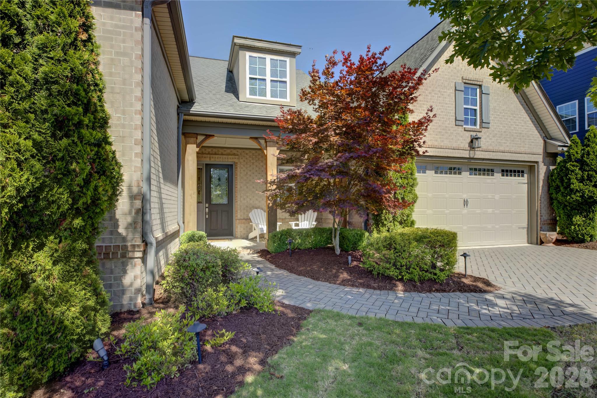Experience luxury living in this charming 1.5-story former model home nestled in the amenity-rich Palisades community. A grand two-story foyer welcomes you inside, where a private study with French doors sits just off the entry. The gourmet kitchen impresses with ample white cabinetry, granite countertops, a prep island with pendant lighting and bar seating, a single-bay sink, a gas cooktop, an exhaust hood, and a wall oven, all flowing seamlessly toward sliding glass doors that open to a screened porch with a stunning stacked stone fireplace—perfect for year-round enjoyment. While enjoying the paver patio, take in serene views of the award-winning Jack Nicklaus–designed Palisades Golf Course. The light-filled living room features a dramatic wall of windows and a stacked-stone fireplace flanked by built-in shelving. The main-level primary suite offers a deep tray ceiling, dual vanities, a double-head glass-enclosed shower, and spacious closets. Bedrooms two and three share a hall bath. Upstairs, a versatile loft provides the ideal media space, along with a private guest suite featuring a full bath. Residents of the Palisades enjoy exceptional amenities, including a clubhouse, resort-style pool, fitness center, tennis courts, playgrounds, miles of walking trails, and access to Lake Wylie, with optional golf and social memberships available at the Palisades Country Club. This home perfectly blends elegance, comfort, and an active lifestyle in one of Charlotte’s most sought-after communities.
