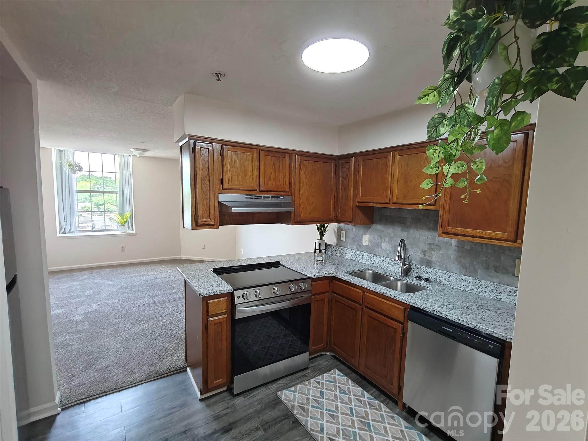 Welcome to this beautifully updated 2-bedroom, 1.5-bath condo located on the main entry level of the highly desirable Locke Mill Plaza. Whether you're searching for a primary residence or an investment opportunity, this move-in-ready unit offers comfort and convenience. Residents of historic Locke Mill Plaza enjoy an array of community amenities, including an inground pool, picnic and grilling area, and controlled-access building entry. Inside offers new paint with an updated kitchen featuring new granite countertops, an undermount sink, and stainless steel appliances, including a smooth-top range, dishwasher, and refrigerator. The open living and dining area include a counter-height. The main-level half bath has been refreshed with a granite vanity top. Upstairs, you'll find primary bedroom with a walk-in closet, while the full bath features a new granite vanity top. A washer and dryer located on the upper level will convey with the sale. Ideally situated, you'll enjoy easy access to restaurants, coffee shops, shopping, and year-round community events.