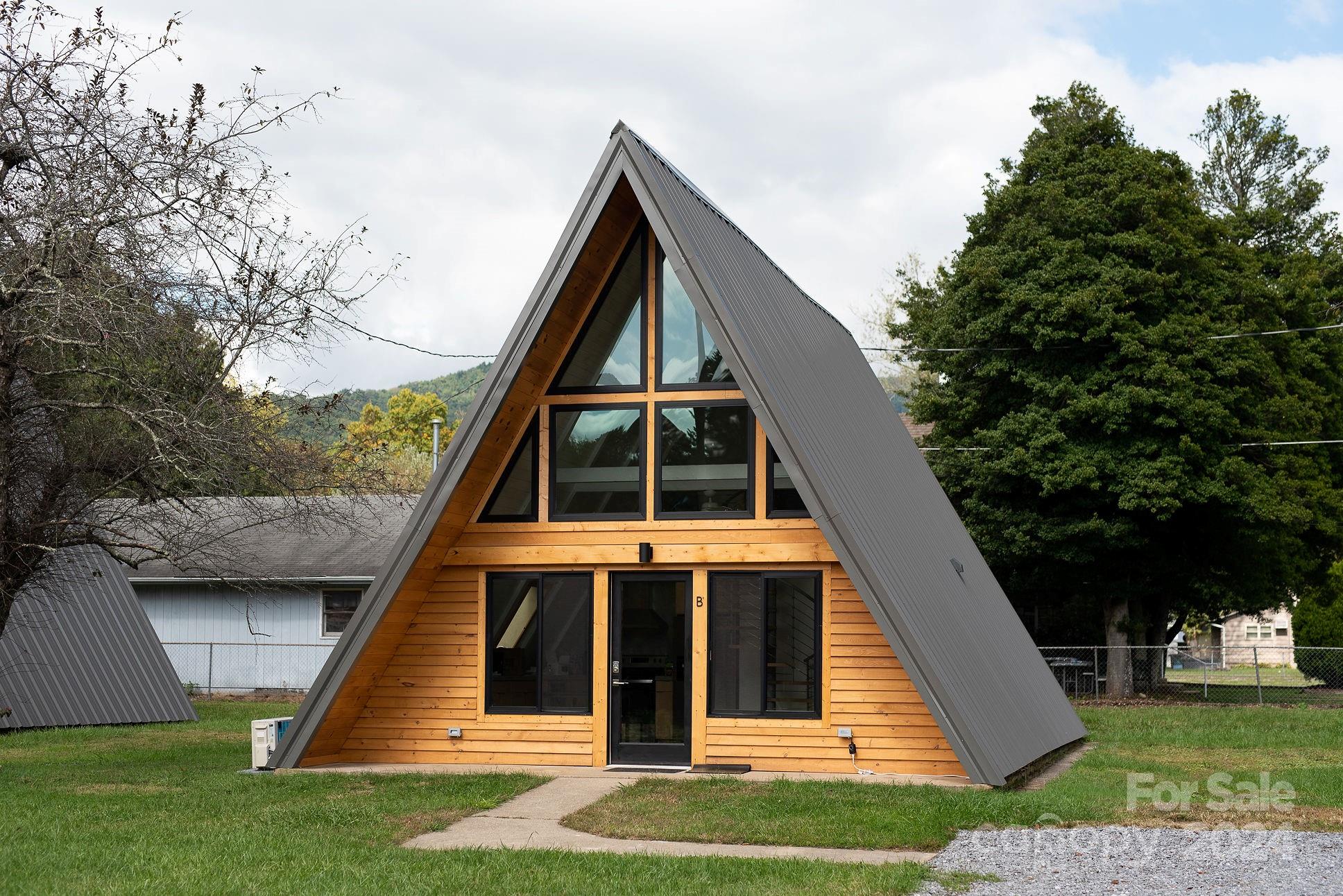 Stunning A-Frame STR in beautiful Black Mountain! High performing airbnb in an amazing location walkable to Downtown Black Mountain via greenway. Renovated in 2021. Perfect for a second home or condo alternative. Curb appeal for days and impeccably designed with a mountain-modern style. The kitchen, dining, and living room combo takes advantage of the soaring ceilings allowed by the A-frame construction, and there's an impressive spiral staircase focal point that renters adore. Main level bedroom plus a loft bedroom, both with king-sized beds. There's a full bath and cozy reading nook. Lovely mountain views from the upper level windows. Fully furnished and provisioned with 164 amazing reviews on Airbnb. This listing is subject to subdivision by seller. Preliminary plat attached and seller will proceed with subdivision after accepted contract.