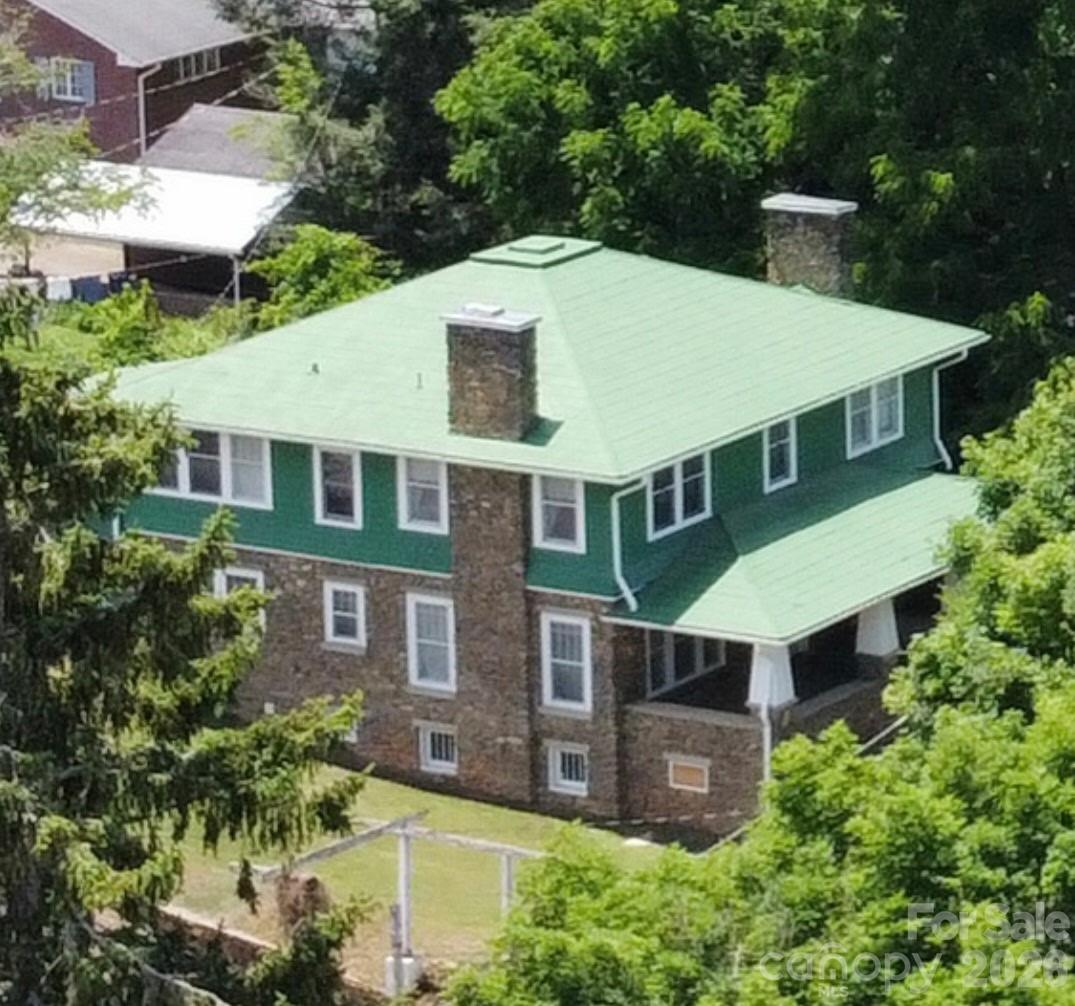 Nestled in the heart of downtown Waynesville, this historic 4-bedroom, 2.5-bath residence offers approximately 2,884 square feet on a rare in-town .3-acre lot filled with timeless character and untapped potential. Stepping inside feels like traveling back in time, with many original furnishings and vintage elements still remaining in the home, offering a glimpse into its rich history and legacy. Select furniture pieces may convey with the sale, though not guaranteed. The property is a true fixer-upper and presents an exceptional opportunity for restoration-minded buyers, investors, or historic home enthusiasts seeking to thoughtfully preserve and modernize a classic Waynesville residence. Features include spacious rooms,  fireplaces original character throughout, a newly constructed oversized garage, and a newly installed concrete driveway — providing a valuable head start for future improvements. Located just moments from downtown dining, shopping, and year-round events, this property offers the rare chance to restore and reimagine a historic mountain home in one of Waynesville’s most desirable in-town settings.  Subject to upset bid and Court approval in Haywood County File No. 25SP000243-430.