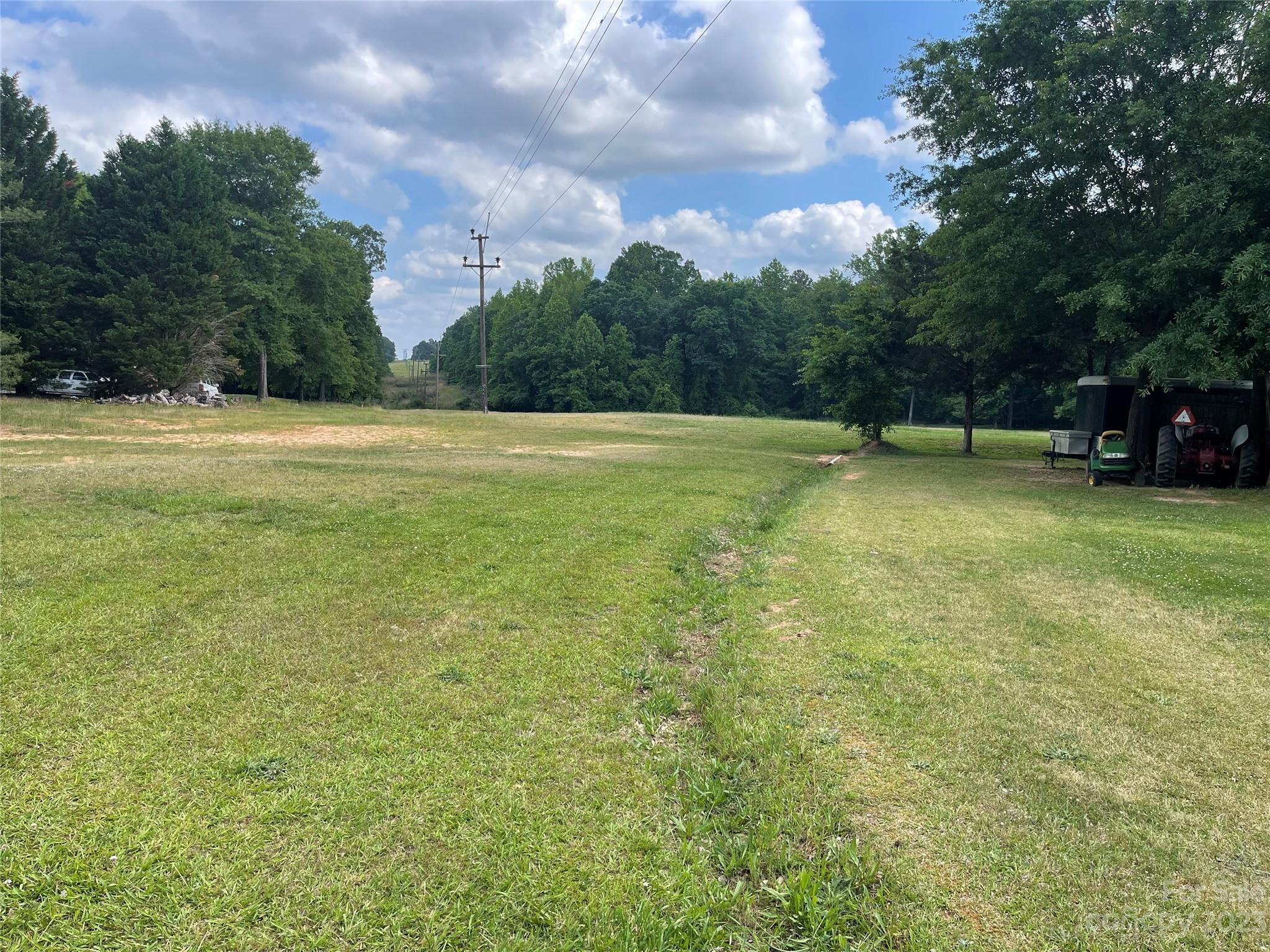 An incredible 3.27 -acre parcel, approximately 1/4 of a mile from the Fort Mill Parkway. York County zoning residential mixed (RMI-10) gives the buyer options to divide. Twenty-five miles to Charlotte airport.Less than three miles to downtown Fort Mill. Award-winning  Fort Mill schools. Duke Energy has a right of way that crosses this property. Single-wide mobile home and outbuildings are not part of the sale. Only land is offered for sale