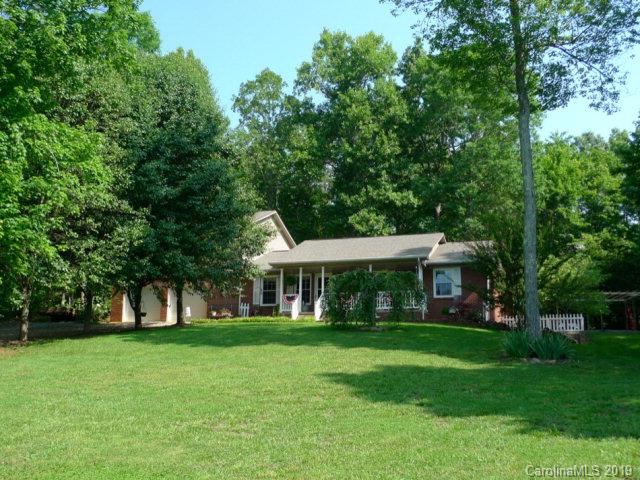 Very private country home in peaceful setting. Plenty of space for pets and family on this 2+ acre parcel surrounded on 2 sides by Mecklenberg County Camp land. Spacious and updated ranch with huge, private master suite addition in 2011.. Main level great room has open kitchen, dining and living area with new flooring. Three bedrooms on main level with shared full bath in hall and private half bath in one. Large laundry/mudroom with storage off 2 car garage. Fully finished lower level has 2 additional rooms that can be used as bedrooms or office/den space and full bath. Large family room with wood stove and french doors to the patio. Enjoy the outdoors with covered front porch, private balcony off master suite, oversized deck with built in benches, pergola with swing and fire pit. Wooded yard and plenty of open space for a garden too.