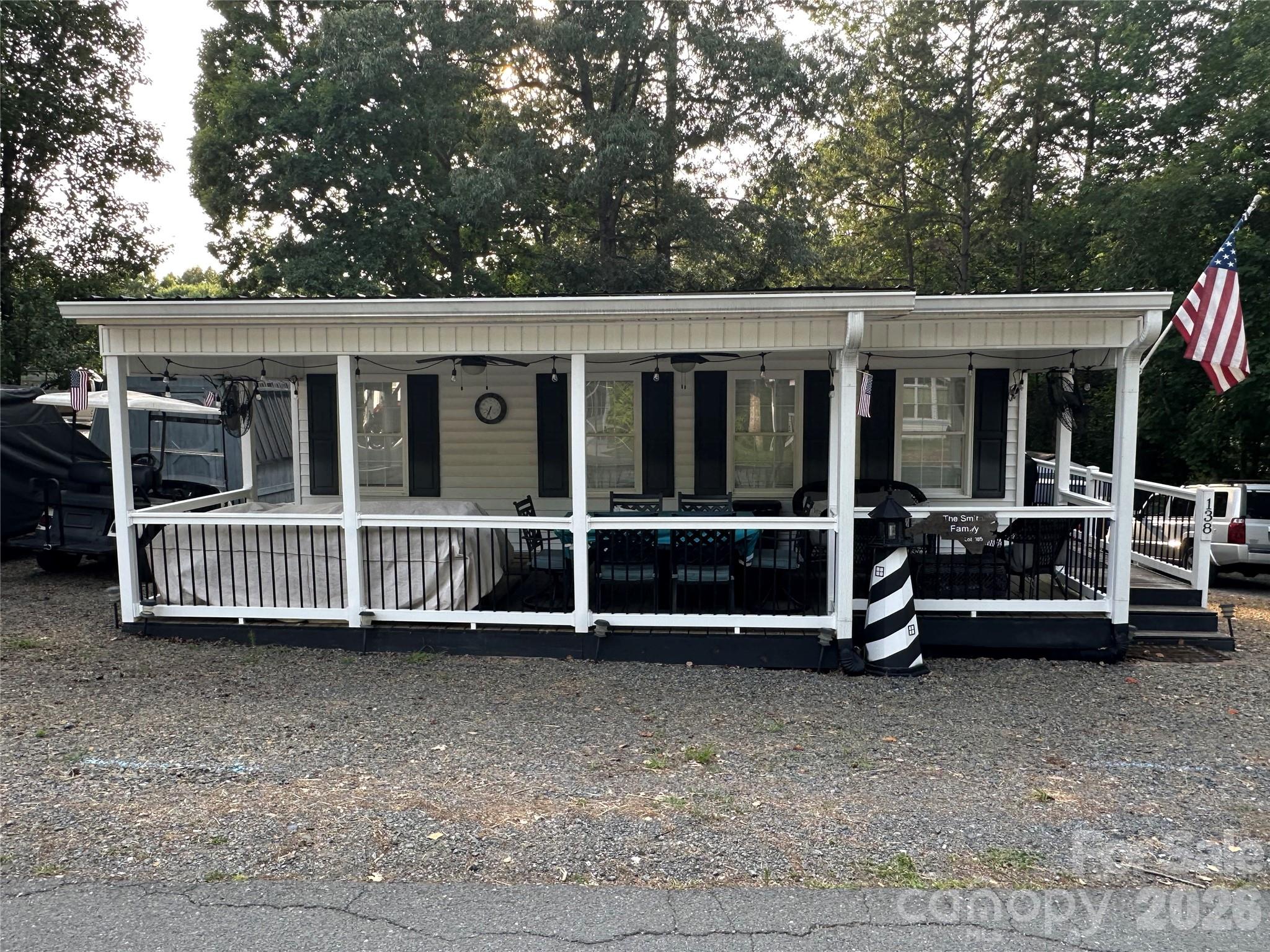 Enjoy affordable lake living in this furnished getaway located on a corner lot in Badin Shores Resort at Badin Lake! This well-maintained property features a camper with a room addition, offering 3 bedrooms and 1 full bath, plus a spacious covered porch that's perfect for relaxing after a day on the water. Abundant parking provides plenty of space for vehicles, golf carts, and even your boat. Most furnishings convey, so simply bring your clothes and start enjoying the lake lifestyle. Conveniently located in the heart of the resort with easy access to the marina, boat ramp, swimming pool, basketball courts, putt-putt golf, and many of the community's popular amenities. Badin Shores Resort also offers a sandy beach, waterfront boardwalk, fishing pier, playgrounds, clubhouse, restaurant, fitness center, and 24-hour security at the entrance. Don't miss this opportunity to own your own lake retreat!