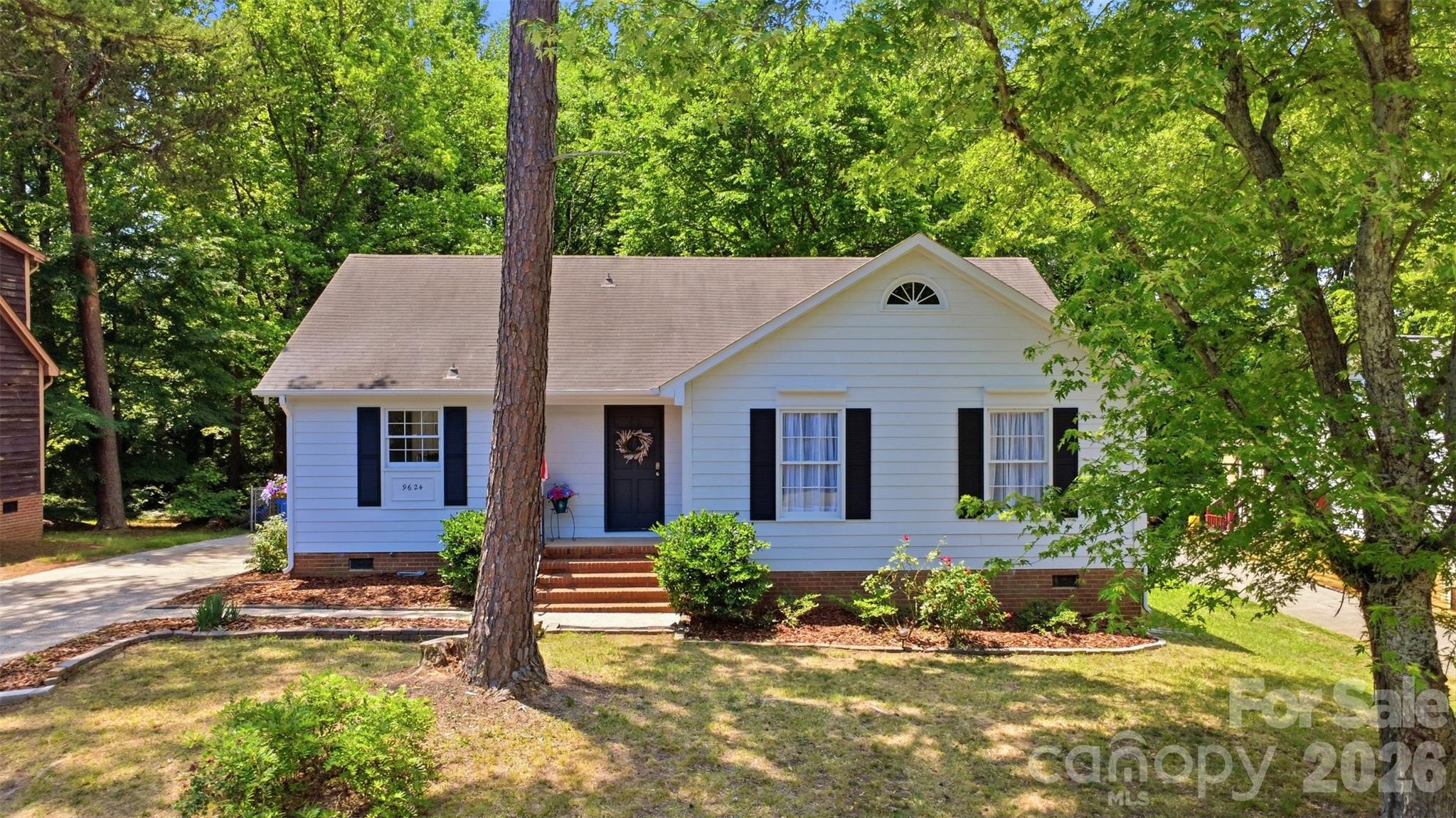 Nestled in a highly desirable location near both Mint Hill and the heart of Charlotte, this beautifully renovated 3-bedroom, 2-bath ranch offers the perfect blend of comfort, style, and convenience. Located just approximately 20 minutes from Uptown Charlotte, this home is ideal for commuters seeking move-in-ready living close to the city.

Inside, you’ll find thoughtful updates throughout, including luxury vinyl plank flooring, updated lighting, beautiful wood doors, stylish hardware, and renovated bathrooms. The inviting living room features textured wood accent walls, a cozy dining niche, and a warm atmosphere perfect for entertaining and holiday gatherings.

At the center of the home is a charming wood-burning fireplace, while the expansive rear great room addition provides incredible flexibility for family gatherings, a media room, game room, or entertainment space.

The spacious primary suite includes a beautifully updated en suite bath with a new shower enclosure and an adjoining dressing room featuring abundant natural light, elegant lighting fixtures, and a walk-in closet. Two additional bedrooms offer generous space, including a corner bedroom large enough to comfortably accommodate a queen-sized bed.

The updated kitchen boasts new shaker-style cabinetry, a pantry, new range/oven and dishwasher, plus a refrigerator with icemaker that conveys. The washer and dryer will also remain at no additional value.

A unique bonus feature is the walk-in basement-level storage/workshop beneath the great room addition — ideal for a home gym, hobby space, workshop, gaming area, or additional storage.

Outside, enjoy a fenced rear yard perfect for pets, play, or outdoor entertaining.

Move-in-ready homes in this condition priced below $400,000 are a rare find in today’s market!
