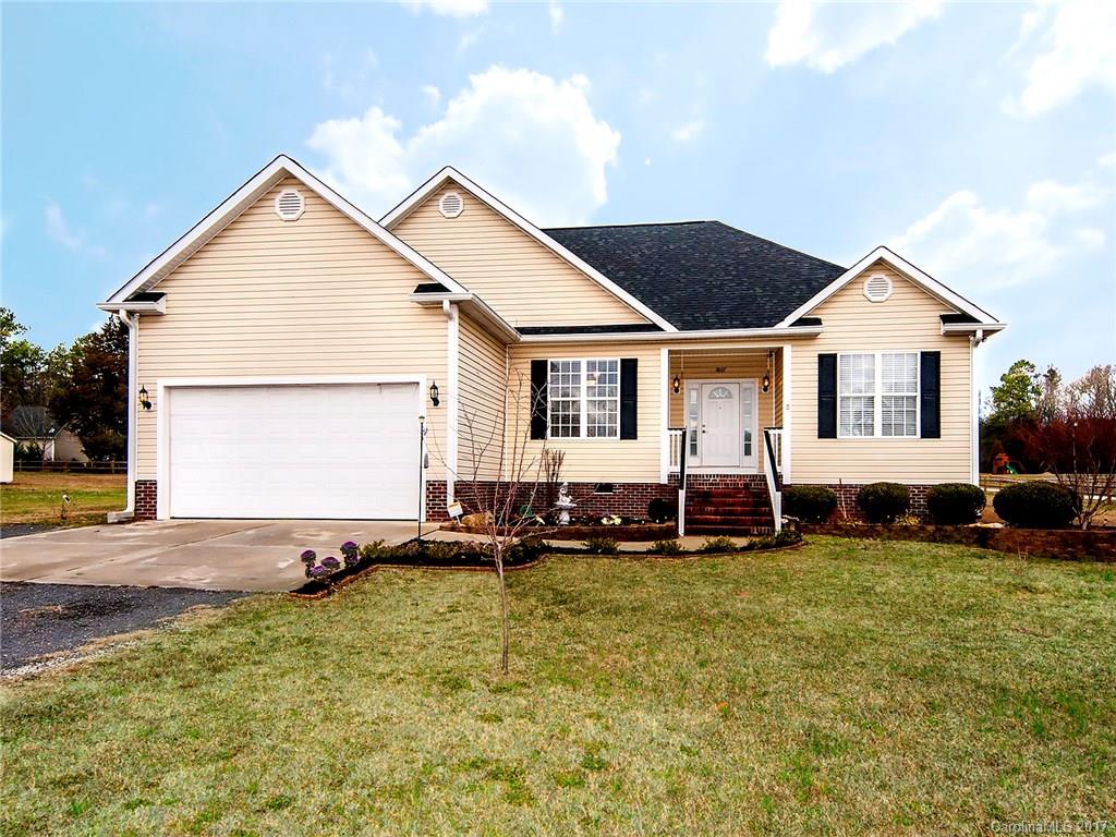 Come and stretch out on this beautiful piece of land. Ranch style home with a salt water pool AND hot tub! The fenced in pool has a deep end with a diving board as well as a 3 foot deep section large enough for a game of volleyball. Three bedrooms, two baths with a gas fireplace. Security system and surround sound included. Come see this adorable home located on a +1 acre lot. The storage shed outside of the fence remains. Storage building in the pool area has a sink and toilet in it.