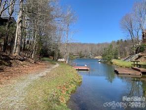 Lovely wooded lot facing Lake Tiaroga. This lot has a gentle slope perfect for building your Dream Home. It has a great location close to the Clubhouse and many amenities. These include 4 lakes, pickleball and tennis courts, swimming pool, hiking trails wellness center and more! This corner lot also has community water and sewer for your building convenience. Come take a look and discover the breathtaking views and welcoming Community of Connestee Falls!