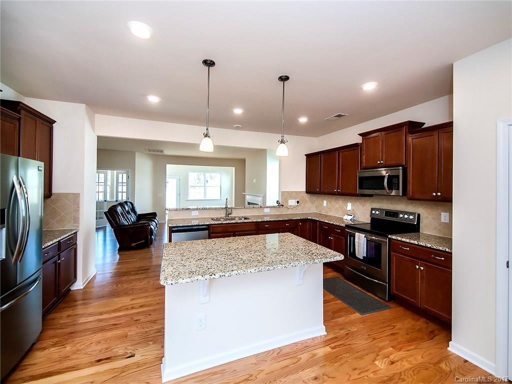 PRICED BELOW NEW CONSTRUCTION.  Check out this SUPER CUTE ALMOST BRAND NEW HOME!  This home features hardwood floors in the main area, fireplace, granite countertops, stainless steel appliances, sunroom, office, master on the main floor, bonus room upstairs, full bathroom and bedroom upstairs, and is on wooded lot.  Come check it out today!