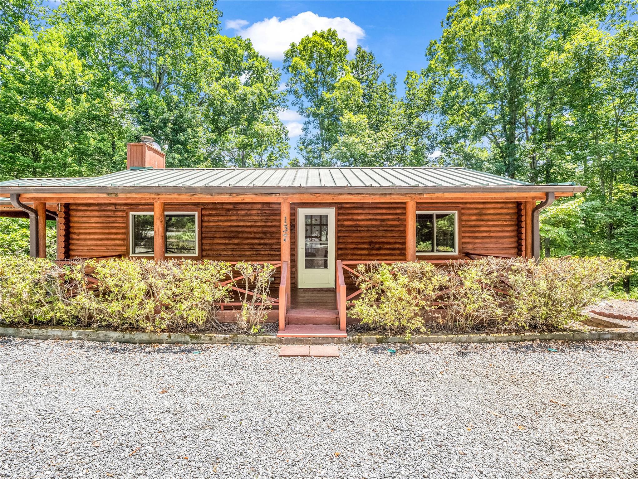 Tucked among the trees in the desirable Riverbend community of Lake Lure, this inviting log cabin offers the mountain lifestyle you've been dreaming of. From the moment you arrive, you'll appreciate the natural setting, rustic craftsmanship, and welcoming atmosphere that make this home so special.  Inside, rich wood accents and a beautiful stone fireplace create a warm and comfortable gathering space, perfect for cozy evenings with family and friends. The two-bedroom, two-bath layout is thoughtfully designed for relaxing weekends, family vacations, or everyday living. Step outdoors to enjoy the best of mountain life with morning coffee on the front porch, cookouts and entertaining on the spacious back deck, and peaceful evenings under the stars surrounded by nature's beauty.  Whether you're searching for a personal mountain retreat, a full-time residence, or a property with income-producing potential, this cabin offers exceptional flexibility. Its desirable location, charming character, and appeal as a vacation destination create exciting opportunities for short-term or seasonal rental use, subject to applicable regulations and community guidelines.  This is more than a cabin. It's a place to slow down, recharge, and make memories for years to come.  Don't miss the opportunity to own your own slice of mountain paradise in Riverbend. Schedule your private showing today.
