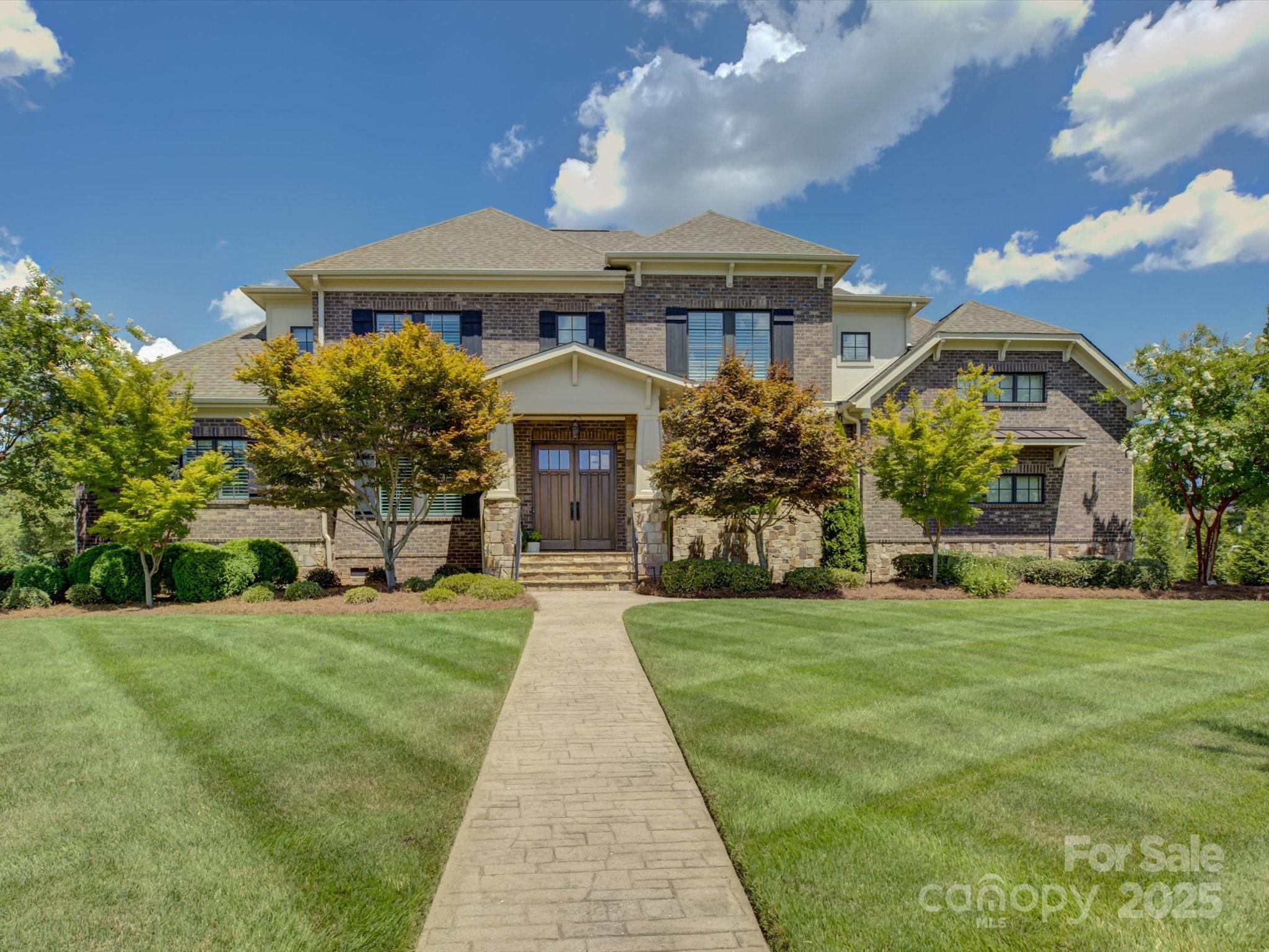 Exceptional custom home with the most inviting back yard pool & spa in the sought-after, luxurious neighborhood of Longbrooke! Excellent location in the gated, picturesque community so close to all the new conveniences Indian Land has to offer, and just minutes from Fort Mill, Ballantyne, and I-485! This pre-inspected, meticulously maintained 5 bedroom/3.5 bath home is perfection! The en-trend kitchen features lovely quartz countertops, an entertainer's island, and impeccable finishes. All bathrooms have been tastefully renovated and updated! Fresh paint, new carpet upstairs, and designer wide plank wood flooring (2025). Additional special features include plantation shutters throughout, a remodeled laundry room, 2 home offices, and a newer tankless water heater. Enjoy the gorgeous private backyard retreat with a heated gunite saltwater pool, built-in grill and stone fireplace, and dreamy covered porch! Professional landscaping and irrigation. Truly a stunning property- a must see!