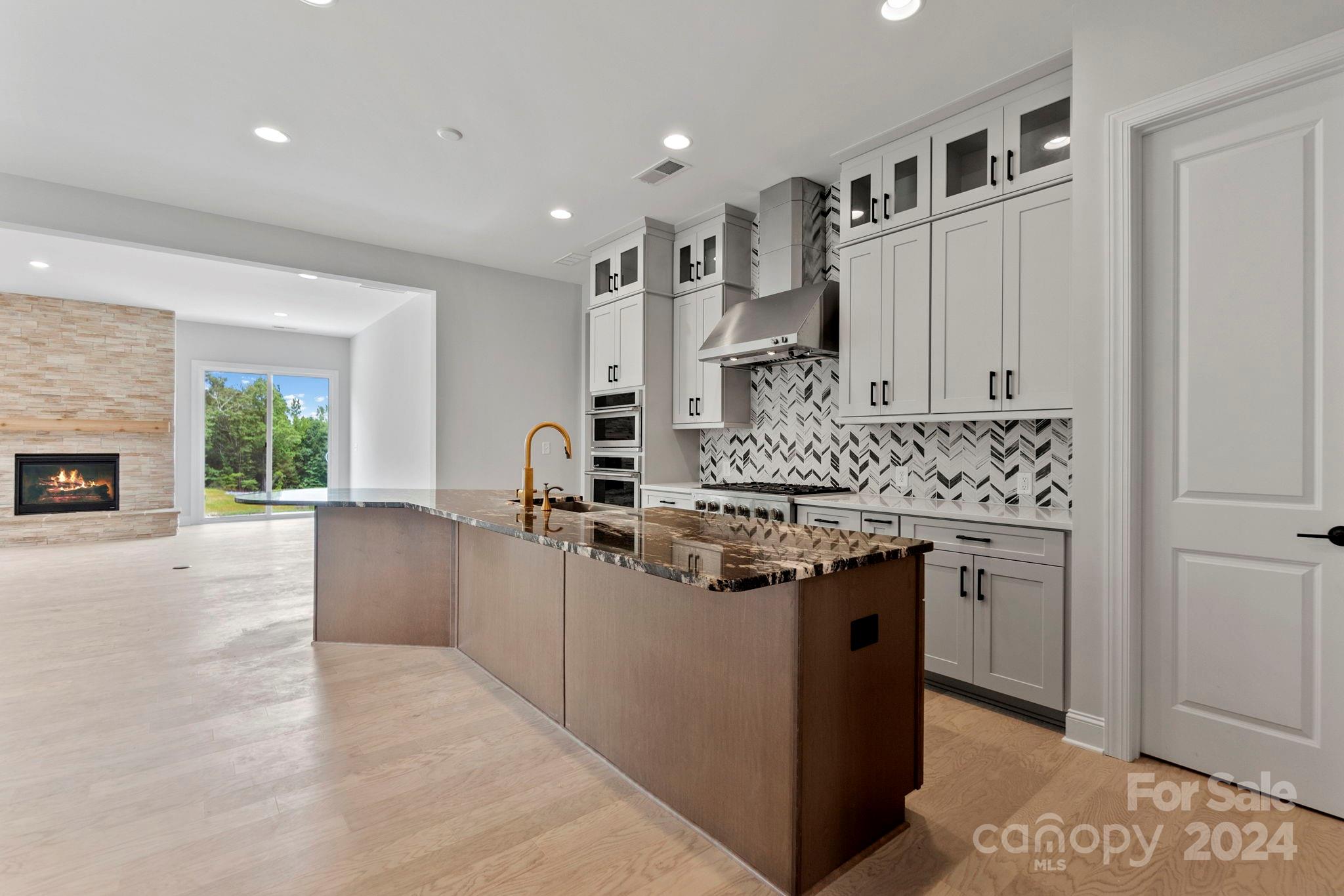 MLS # 4097653 REPRESENTATIVE PHOTOS ADDED. Summer Completion! The Whitmore II features a spacious open-concept layout, including a large gathering room, casual dining area, and a unique kitchen with a boomerang-shaped island. A dedicated dining room is conveniently placed near the foyer. Unique elements include a second suite down the hall, walk-in closets in both secondary bedrooms, and a lengthy 2-car garage for extra storage. The owner's suite on the main floor offers comfort and luxury with a spacious bath, walk-in closet, dual sinks, and a dedicated shower enclosure. The second floor adds versatility with a loft, attic suite, and unfinished storage space. Structural options include: tray ceilings, second suite on main floor, covered outdoor living, additional windows, fireplace, and laundry sink.