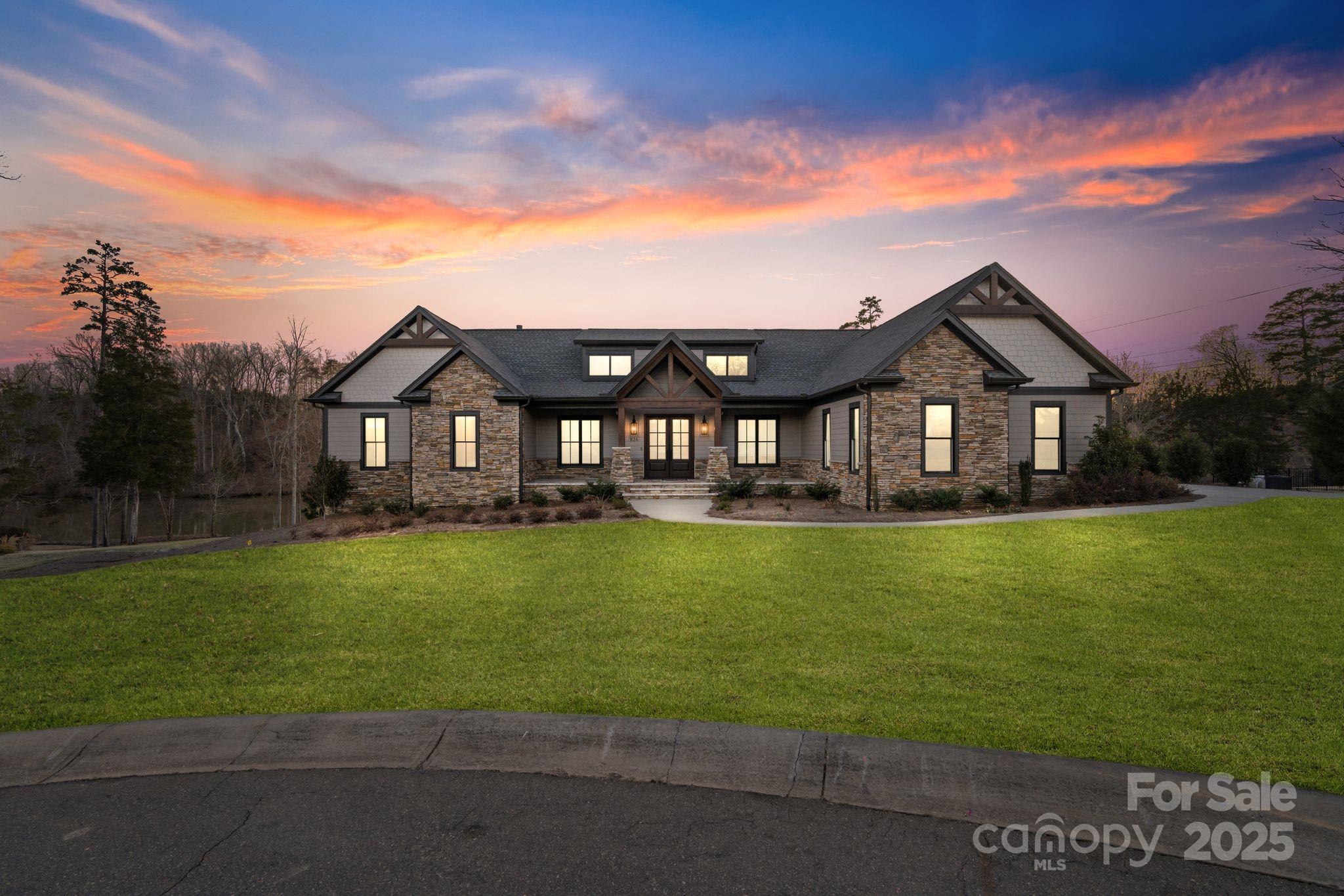 The luxurious lakefront lifestyle awaits at this stunning 4-bedroom, 3.5-bath custom waterfront home on Lake Wylie! As you enter, you'll immediately be captivated by the expansive open-concept living area, highlighted by beautiful exposed wood beams. The gourmet kitchen is perfect for entertaining, with ample storage, sleek appliances and modern finishes throughout. The main level also boasts a large primary suite with en-suite bathroom, spacious walk-in closet and attached laundry room. Enjoy breathtaking views of the lake from the two-story back porch directly off the main living area!

The partially finished basement offers 2,600+ sq ft of endless possibilities, with plenty of space to add your personal touch and customize to fit your needs.  The basement also creates the opportunity to add additional bedrooms and bathrooms to the home. Whether you envision a home theater or game room, the options are truly limitless!