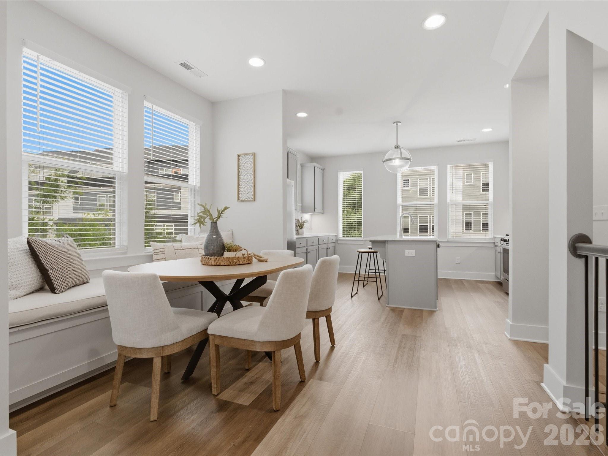 6 MONTHS OF PREPAID HOA FEES! Newer construction — with a rooftop terrace — this end-unit in Seversville delivers stylish, low-maintenance living in one of Charlotte’s most up & coming areas. Enter through your 2-car garage or the front door & head up to an open-concept main level with 9’ ceilings & great natural light. Super natural flow between the kitchen, dining, & living spaces. The kitchen features a large island with marble countertops, 42' shaker cabinets, a gas range, modern hex tile backsplash, & a custom built-in dining bench that adds both character & function in the dining area. Living room is sizeable & opens to a balcony overlooking the community greenspace. Upstairs, the primary suite offers city views, a dual vanity, & a tile shower, while the secondary bedroom includes a stylish feature wall & easy access to a full bath. No carpet!! Top floor flex space with half bath is perfect for a home office, gym, or hangout spot — opens to your private rooftop terrace, ideal for hosting or unwinding. Bonus perks: attic storage, a dog park just steps from your front door, & quick access to Uptown, Camp North End, NoDa, & the Gold Line. HOA covers lawn care, water, sewer, & trash.