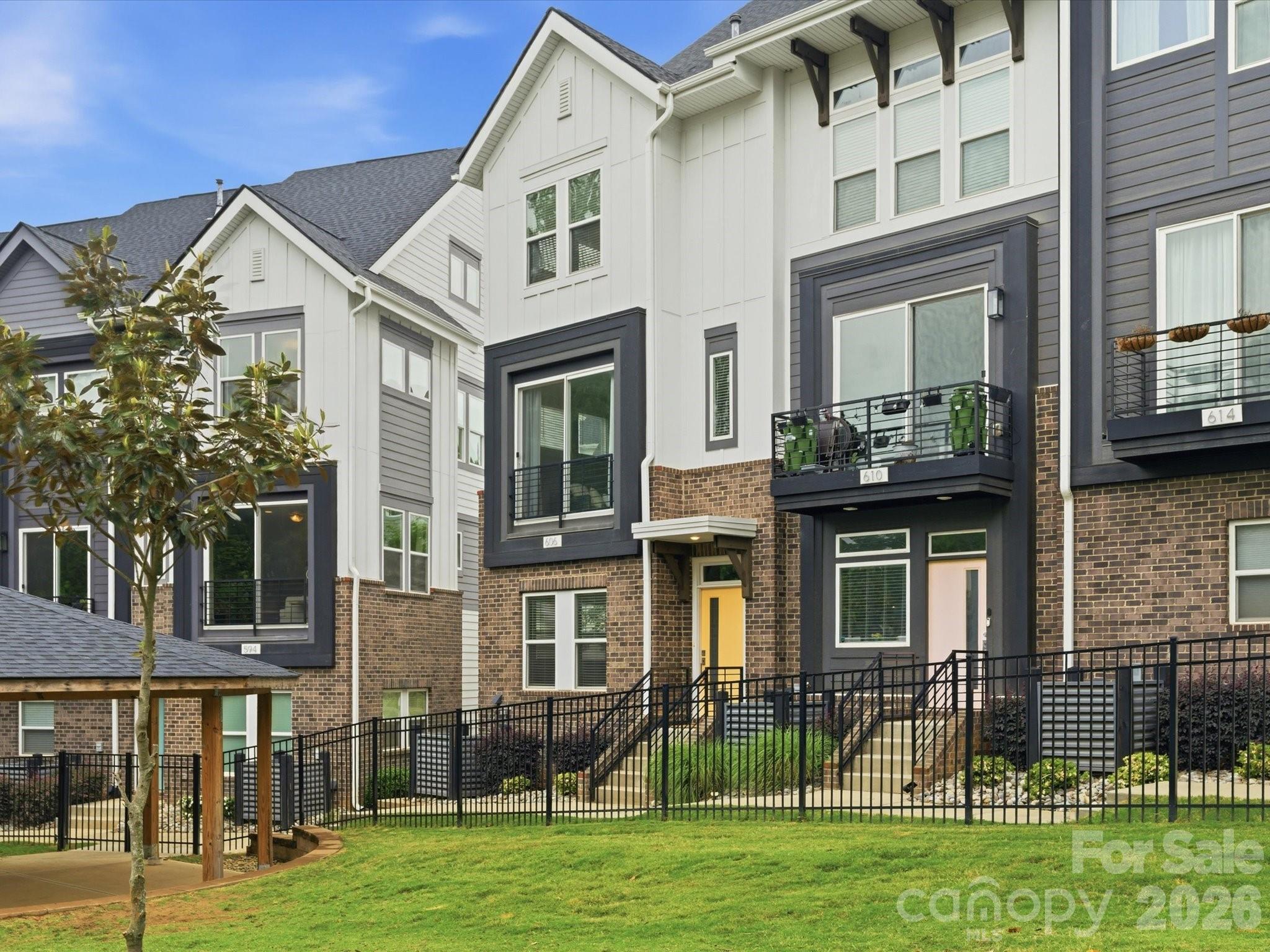 6 MONTHS OF PREPAID HOA FEES! Newer construction — with a rooftop terrace — this end-unit in Seversville delivers stylish, low-maintenance living in one of Charlotte’s most up & coming areas. Enter through your 2-car garage or the front door & head up to an open-concept main level with 9’ ceilings & great natural light. Super natural flow between the kitchen, dining, & living spaces. The kitchen features a large island with marble countertops, 42' shaker cabinets, a gas range, modern hex tile backsplash, & a custom built-in dining bench that adds both character & function in the dining area. Living room is sizeable & opens to a balcony overlooking the community greenspace. Upstairs, the primary suite offers city views, a dual vanity, & a tile shower, while the secondary bedroom includes a stylish feature wall & easy access to a full bath. No carpet!! Top floor flex space with half bath is perfect for a home office, gym, or hangout spot — opens to your private rooftop terrace, ideal for hosting or unwinding. Bonus perks: attic storage, a dog park just steps from your front door, & quick access to Uptown, Camp North End, NoDa, & the Gold Line. HOA covers lawn care, water, sewer, & trash.