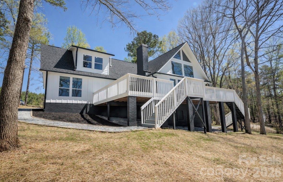 Welcome to your perfect waterfront retreat on Lake Wateree! This remodeled lake home offers the best of both worlds—calm waters for relaxing and breathtaking long-range views of the main channel. This 5-bedroom, 3-bath home is designed for comfort and lake living. Step inside to find a warm and inviting living space featuring beautiful high ceilings with tons of natural light and a cozy wood-burning fireplace. The kitchen and bathrooms have been meticulously updated. Enjoy year-round lake views from most rooms, or step outside onto the spacious wrap-around porch. The second-floor balcony provides another stunning vantage point overlooking the water. Outside, the large lot offers plenty of space to spread out, you may also enjoy the fully finished basement space offering a private exterior entrance, natural light, heated and cooled- Ideal for guests or a comfortable, separate living area after a day on the water! a cozy gazebo and pier dock—make it easy to get out and enjoy the lake at a moment’s notice. this property combines relaxation, recreation, and scenic beauty all in one. Whether you’re looking for a full-time residence or a weekend getaway, this Lake Wateree home is ready for you to start making memories. Exceptional value for this area—don’t miss this opportunity.
