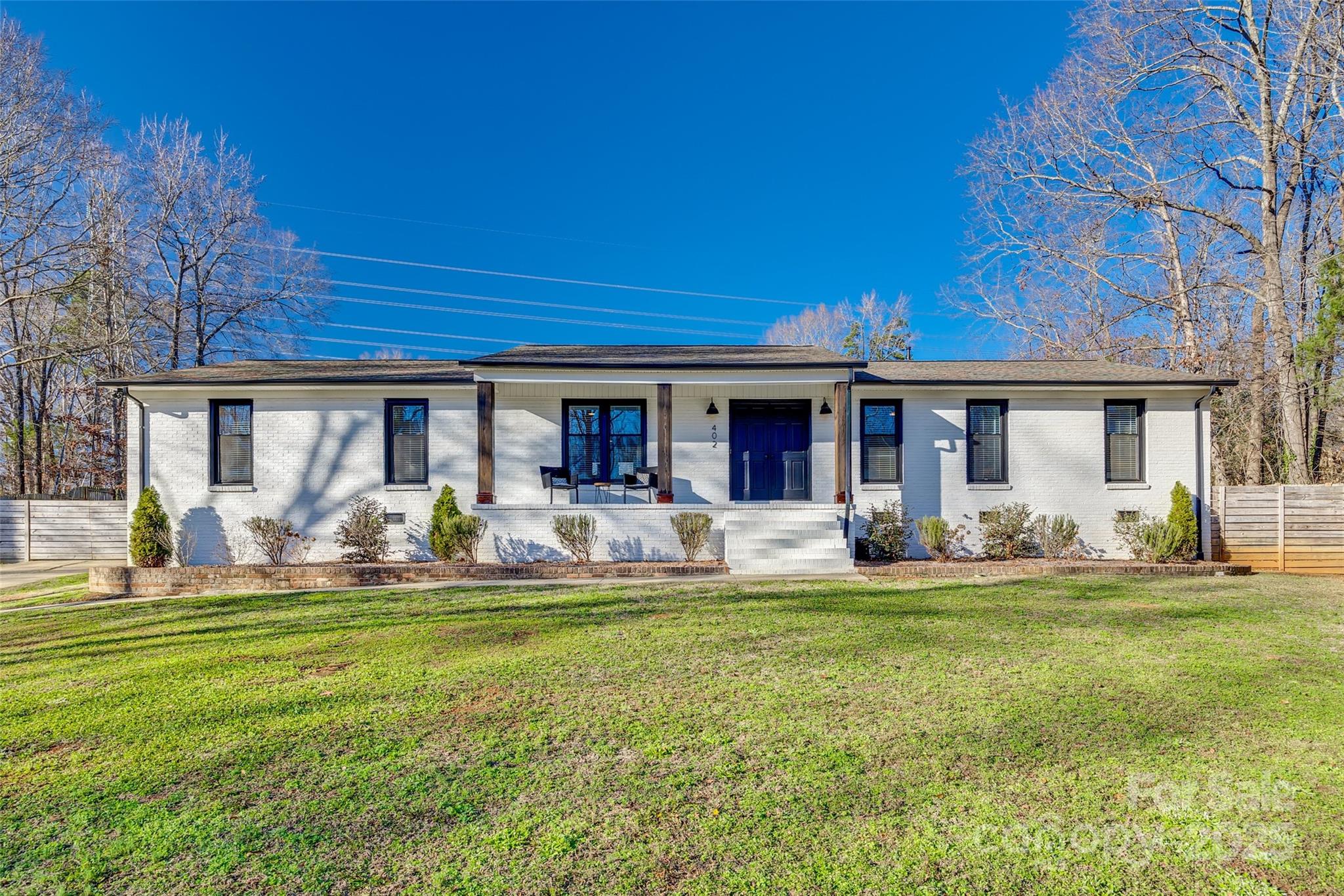 Discover this tastefully updated brick ranch in the highly sought-after Forest Lake community of Fort Mill, offering over an acre of serene living with no HOA. This home has been thoughtfully refreshed to combine modern style with classic charm. The open-concept layout showcases a stunning 8.5' quartz island, ideal for entertaining. One room offers versatility as a guest suite, home office, flex or bonus space, perfectly tailored to your needs. Head outside to a rare oversized lot with a private, usable backyard—a perfect retreat. Enjoy tranquil views of the lake while staying conveniently close to shopping, dining, and I-77 for easy commuting. This home delivers the ultimate blend of comfort, privacy, and accessibility. Don’t miss your chance to make it yours!