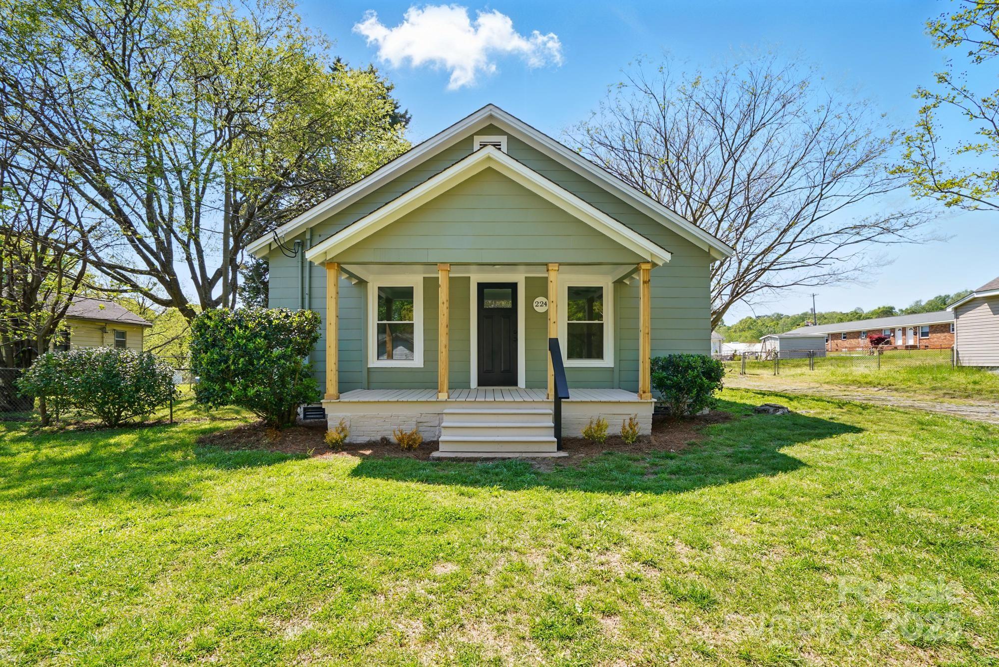 Very cute, remodeled home in convenient location. Appox. 5 min from I-85.  Home is located in the heart of Mount Holly.  Large lot, partially fenced.  Covered front porch.  New gravel in driveway will be put in soon.  Home is quaint and has a lot of character, including built-ins in dining room and small bedroom.  New flooring throughout. Although fireplace is not functional, mantel adds a touch of charm and a place to hang your Christmas stockings.  Kitchen features white cabinets and guartz countertops, new stove and microwave.  Small butcher block in kitchen remains with house.  Seller has installed little shelves for decorative items.  All pulls, knobs and door knobs are black for decorative accent.   Main bath shower tiled with subway tile.  Both baths have new sinks and cabinets.  Back yard is partially fenced.  Large new deck on back; rod iron table and chairs remain with house.  Separate laundry room/mud room on back of house.