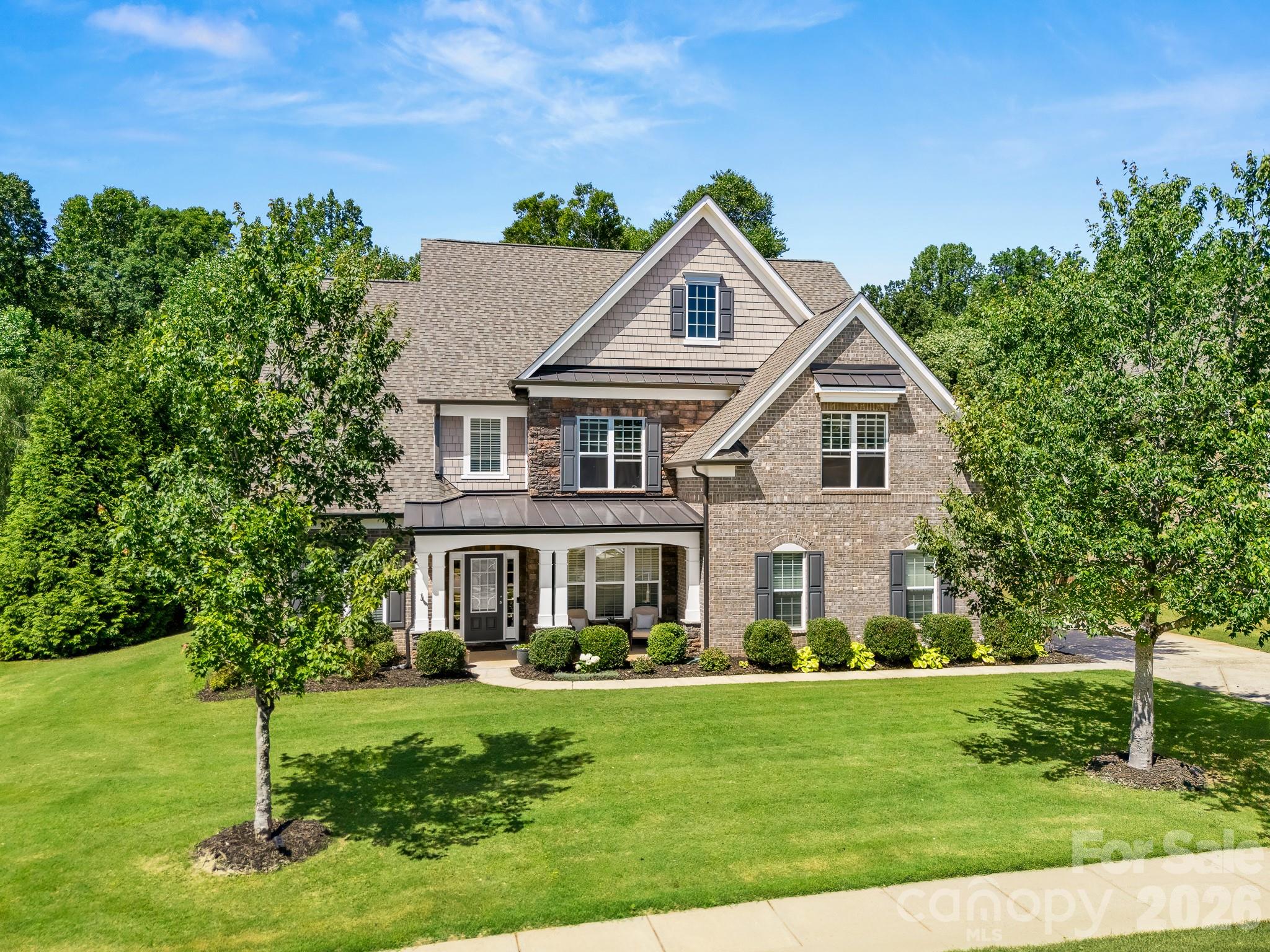 The lot is the star of the show here at the end of the cul-de-sac - 10704 Waxhaw Manor. The large covered back porch and fireplace overlooks a private, wooded, tranquil backyard creating a true nature experience. Kitchen is open to family room with a full bath and bedroom on the main. Primary, 3 secondary bedrooms and a bonus room upstairs. Interior is nicely updated with paint, lighting and new carpet. Easily walkable to Sandy Ridge Elementary School. MOVE IN READY! The Chimneys of Marvin offers world class amenities for a true lifestyle experience; pool, clubhouse, playground, tennis and sidewalks throughout.