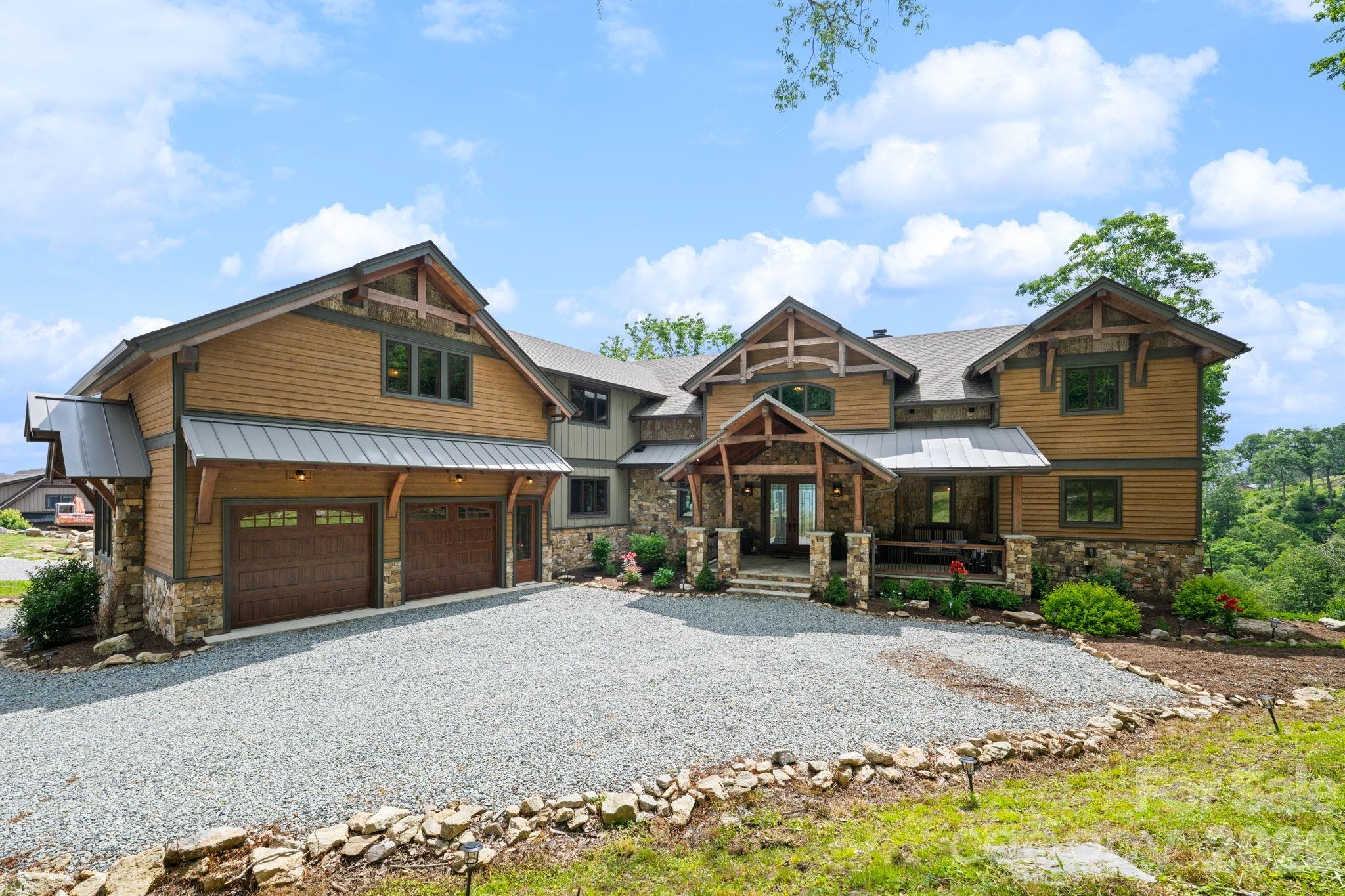 Live the elevated mountain lifestyle at over 4,500 feet in The Lodges at Eagles Nest, one of the most sought-after luxury gated communities in Banner Elk and the North Carolina High Country. Located in the desirable Great Camp section, this exceptional luxury mountain home offers long-range Blue Ridge mountain views, quality craftsmanship, and an ideal layout for multigenerational living, a second home, or a mountain retreat. What truly sets this home apart is how comfortable and livable it feels. While undeniably impressive, this is not a home designed simply as a showpiece—it is a home designed to be enjoyed. Three levels of living are easily accessible via elevator. The main living area features soaring ceilings, a dramatic floor-to-ceiling stone fireplace, and expansive windows showcasing long-range Blue Ridge views. The kitchen is built for gathering, with an oversized island, leathered granite countertops, abundant cabinetry, a full pantry, and generous prep space. Just off the kitchen, a large butler’s pantry and laundry room combination adds even more storage and functionality. The oversized dining area easily accommodates large gatherings, with room for everyone around the table. With six bedrooms and six-and-a-half baths, this home offers exceptional flexibility for family and guests and is offered furnished. Four bedrooms feature ensuite baths, while three include double closets. Storage is exceptional throughout, with abundant closets. Gathering spaces extend well beyond the main living room. The lower level is a retreat all its own, featuring a comfortable secondary living area, separate game room, two custom bunk rooms, an additional bedroom, and direct access to the hot tub. Designed with multigenerational living in mind, this level creates the perfect setup for kids, teens, or guests to have their own space while still feeling connected to the home. Each bunk room includes its own secret hideaway. Outdoor living is equally impressive. A stunning covered deck just off the dining area features a stone fireplace and inviting seating area for year-round enjoyment. A separate outdoor fire pit creates the perfect setting for cool mountain evenings under the stars while taking in the layered Blue Ridge Mountain views. Additional features include an oversized two-car garage and a separate ATV garage with direct access to Eagle’s Nest’s renowned trail system. While not intended as a high-yield investment property at this price point, the home does generate approximately $100,000 in rental income annually, making it an excellent option for offsetting ownership costs when not in personal use. Whether you are searching for a full-time residence, luxury vacation home, or mountain getaway with income potential, this home offers an exceptional opportunity in one of the High Country’s premier communities. Eagle’s Nest is known as a luxury adventure community, and amenities include ATV trails, hiking, pickleball, tennis, mini golf, an outdoor amphitheater, dining, Eagles Nest Winery, and Epic Chophouse, making this one of the most desirable luxury lifestyle communities in the Southeast.