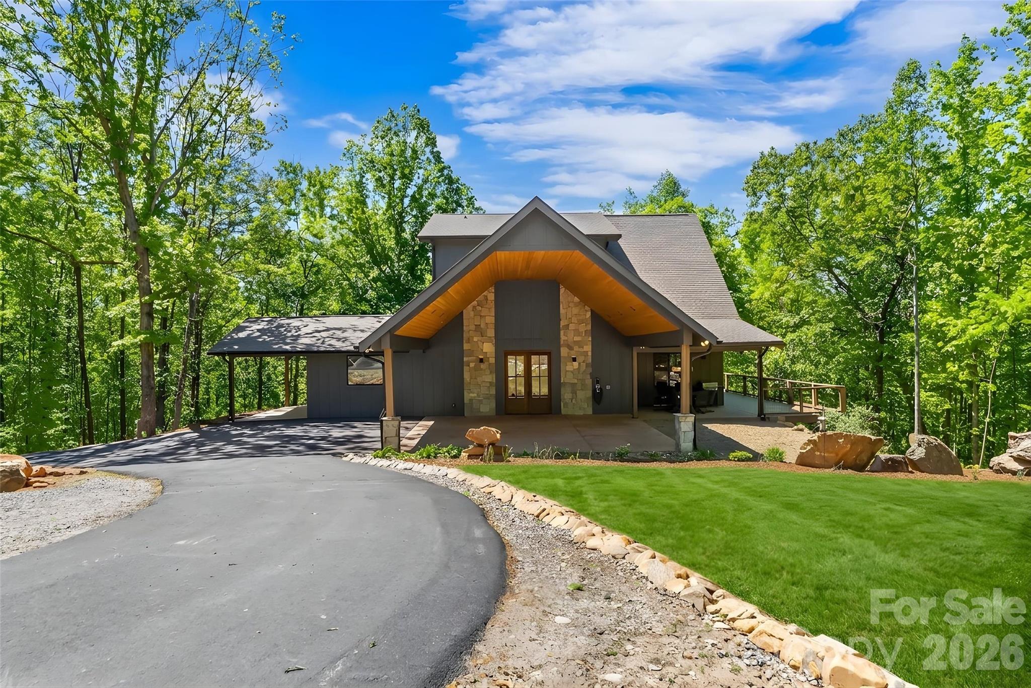 Discover the pinnacle of modern luxury in this 2024 architectural masterpiece, perfectly positioned as a private mountain-top sanctuary on seven sprawling acres. Behind a secure gated entrance, a winding drive leads to a stunning 4,252-square-foot residence designed to blend high-end contemporary living with the serene beauty of the Blue Ridge foothills and picturesque views of Table Rock, Hawksbill, and Mt Mitchell. The heart of the home is a magnificent great room, where soaring ceilings and dramatic 30-foot-tall floor-to-ceiling windows create an immediate immersion into nature, flowing seamlessly into a professional-grade chef’s kitchen featuring expansive quartz countertops, an induction range, and dual high-capacity refrigerator/freezers. The main-level primary suite offers ultimate convenience with a dual-sided tiled shower and a massive walk-in closet with direct laundry access, while the upstairs features a large loft, two bedrooms, and a full bath.  Two offices in the home and high-speed internet make remote work a breeze. The walk-out lower level serves as a complete guest retreat or recreation hub. Engineered for the future and off-grid ready, the home features a complete solar panel array, two Tesla Powerwall 3 backup batteries, dual EV charging stations, and is wired/plumbed for an outdoor wood boiler. Outdoor living is redefined by expansive wraparound decking with hot tub wiring, established fruit trees, RV pad with water/power/sewer hookups, and a level sanded clearing ready for equestrian or recreational use. Enjoy total seclusion without sacrifice, located just 10 minutes from the vibrant dining of downtown Morganton and less than an hour from Asheville or Lake James.  Additional land available, with up to 103 total acres.