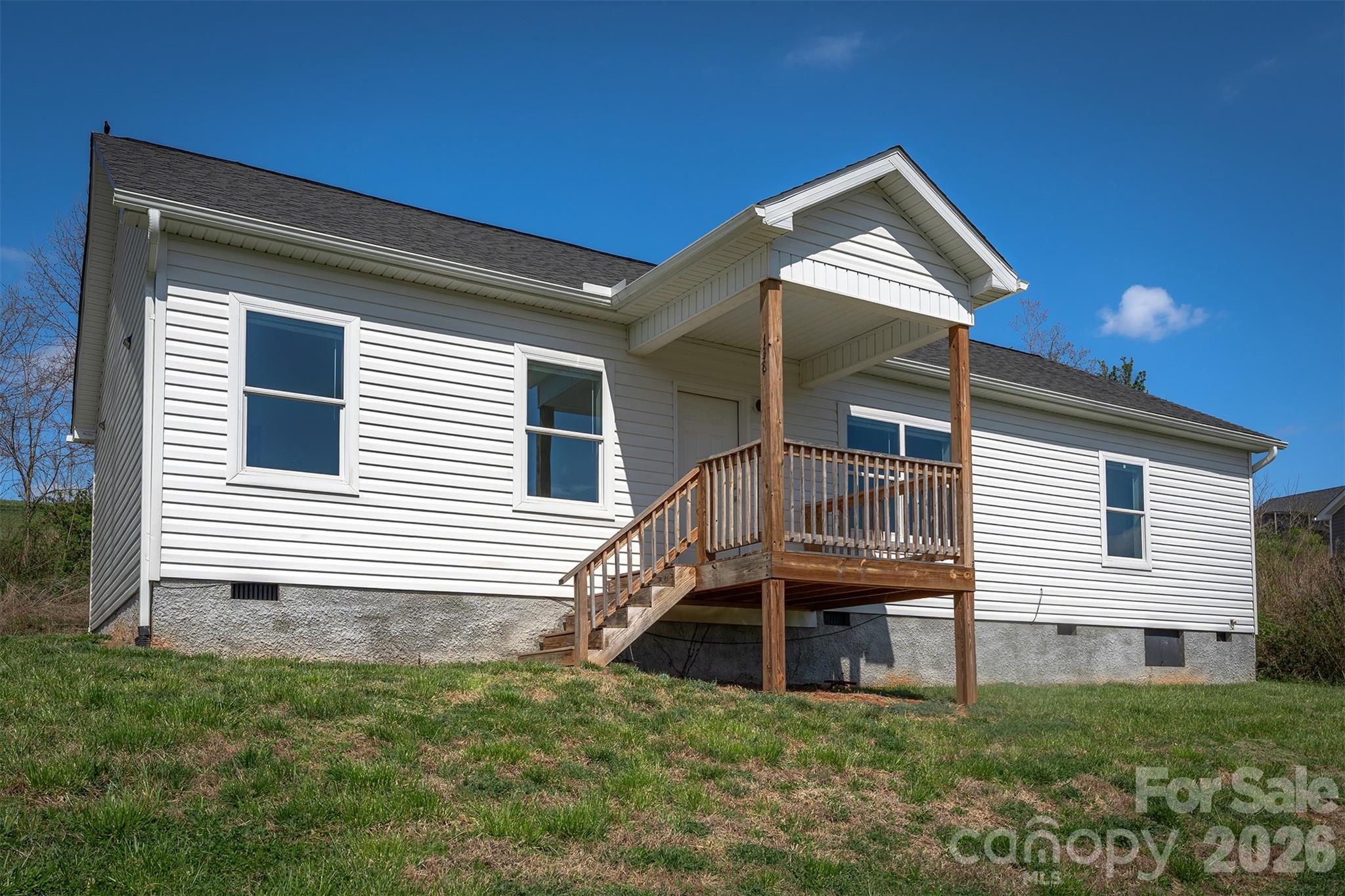Sitting in the Rolling Hills of the French Broad in Alexander, this newer construction 3 bedroom, 2 bath home has views for days and a front deck that is the perfect place to enjoy it. Featuring a split floor plan and a spacious open concept layout that seamlessly connects the kitchen, dining and living room areas.  The kitchen stands out with tall cabinetry, offering lots of storage an upscale feel.  With single-level convenience, this move-in-ready home is a must-see.