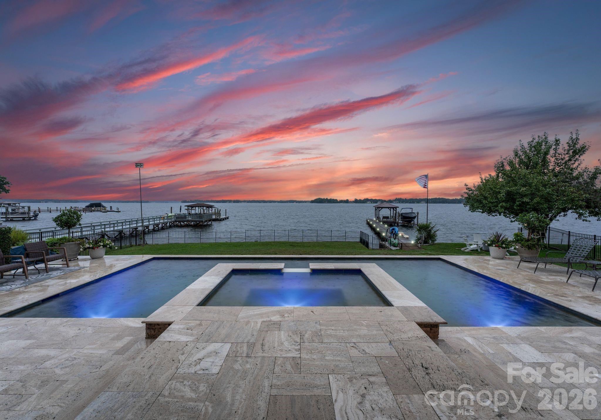 Perched on one of the best lots on Lake Norman, 20732 Eastpoint offers rare deep-water access and sweeping, unobstructed lake views. This 4BR, 3.5BA home plus large bonus/flex room blends refined interiors with resort-style living, including a brand-new in-ground pool and hot tub. The completely updated dock features 8 new pylons, a new covered seating area, resurfaced planks (2020), paver walkway (2026), and new seawall (2026) for years of enjoyment. Inside, Italian tile flows through the main level, complementing a gourmet kitchen with custom cabinetry, granite, and stainless appliances. The living room’s stone fireplace and warm wood accents set the stage for relaxed luxury, while the primary suite’s private balcony captures endless water vistas. Perfect for entertaining or quiet escapes, this home delivers the ultimate Lake Norman lifestyle from sunrise to star-filled nights on the water. Don't miss the opportunity to own one of the best lots on Lake Norman!