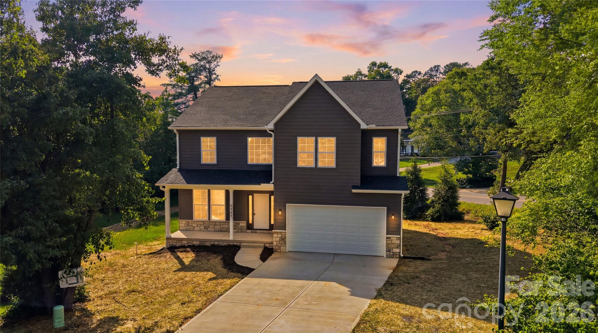 Welcome to 1147 10th Street Lane NW in the desirable The Pines Subdivision, where quality craftsmanship and modern design come together in this newly constructed home by Kiley Homes. Situated on a generous 0.54-acre lot, this impressive two-story residence offers 4 bedrooms, 2.5 bathrooms, 2,718 square feet, and a thoughtful floor plan designed for today's lifestyle. Attractive curb appeal is highlighted by a covered front porch, stone veneer accents, a concrete driveway, and an attached two-car garage. Step inside to discover a stunning two-story foyer that creates a grand first impression and sets the tone for the spacious interior.

The main level features luxury vinyl plank flooring throughout and an open-concept layout that seamlessly connects the primary living spaces. A formal dining room is conveniently linked to the kitchen through a butler's pantry, creating an ideal setup for entertaining and everyday living. The spacious living room serves as the heart of the home and features an electric fireplace, providing a warm and inviting focal point. Large windows allow natural light to fill the space, while a door leads directly to the rear deck, extending your living and entertaining options outdoors. A conveniently located half bath on the main level adds functionality for guests.

The kitchen is designed to impress with stylish quartz countertops, a large island with breakfast bar seating, and abundant workspace for meal preparation and gathering. Appliances include an electric range, microwave, dishwasher, and garbage disposal. The open design allows the kitchen to remain connected to the living spaces, making it easy to entertain while preparing meals. Thoughtful storage solutions and quality finishes throughout reflect the attention to detail that Kiley Homes is known for.

Upstairs, you'll find all four bedrooms, including a spacious primary suite designed as a private retreat. The primary bedroom offers generous proportions along with a large walk-in closet. The en-suite bathroom features tile flooring, a soaking tub, separate walk-in shower, and dual functionality that creates a relaxing spa-like atmosphere. Three additional bedrooms provide flexibility for guests, office space, hobbies, or other lifestyle needs. Each bedroom features its own walk-in closet, offering exceptional storage rarely found in today's market. A second full bathroom with tile flooring serves the additional bedrooms, while a dedicated laundry room with utility sink adds everyday convenience. Additional storage is available with a nearby linen closet.

Combining modern finishes, spacious living areas, abundant storage, and the peace of mind that comes with new construction, this home offers an exceptional opportunity in one of Hickory's sought-after communities. Conveniently located near shopping, dining, recreation, and everyday amenities, 1147 10th Street Lane NW delivers the space, style, and functionality today's buyers are searching for. Don't miss your opportunity to make this beautiful new home your own.