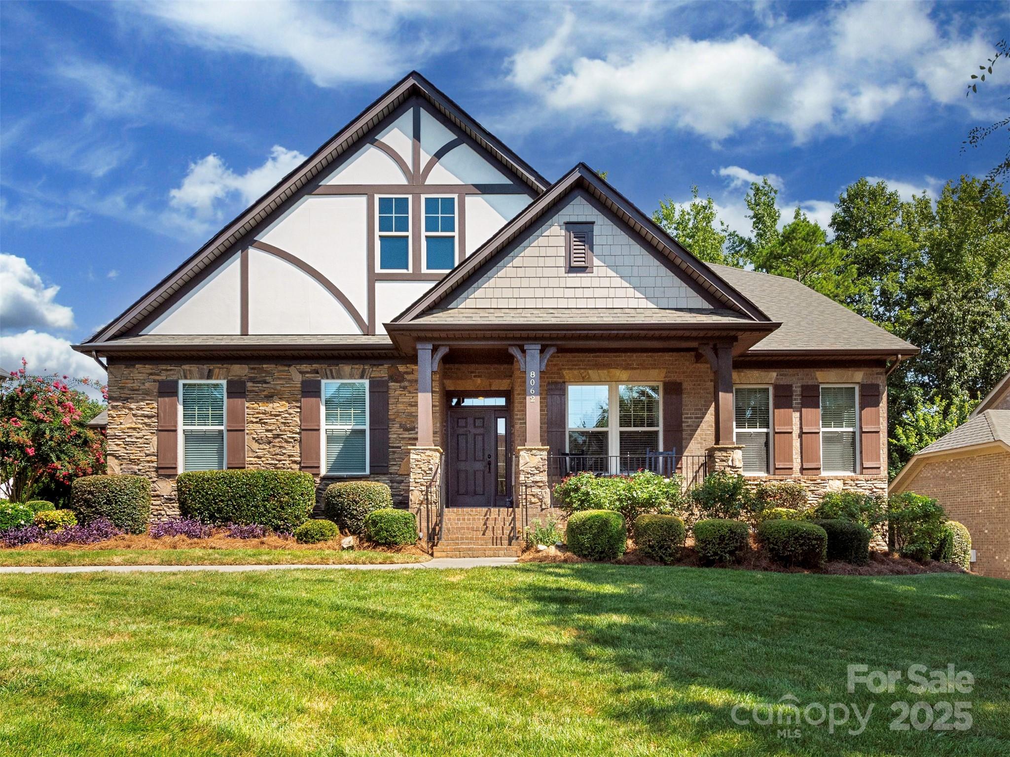 Meticulously maintained full brick home resides in the sought-after community of Barber Rock. This stunning 5-bedroom, 3-bath home provides a spacious primary suite and 2 additional bedrooms on the main floor with 2 large bedrooms upstairs.  The home boasts solid hardwood floors throughout, custom moldings & 2 amazing bay windows. The kitchen is equipped with a Sub-Zero refrigerator to make entertaining fun & easy. The laundry room finishes include custom cabinetry, an undermount sink, a granite countertop and updated tile flooring.  The primary bedroom closet and kitchen pantry have  custom closet systems. Outside features include landscape lighting and irrigation system. The home has a 2-car garage and with an additional carriage garage – both have been updated with new door systems. The main floor includes a 4-ton HVAC system. Barber Rock amenities include an outdoor pool, playground, & recreation areas. Conveniently located near Fort Mill, Indian Land, and Ballantyne