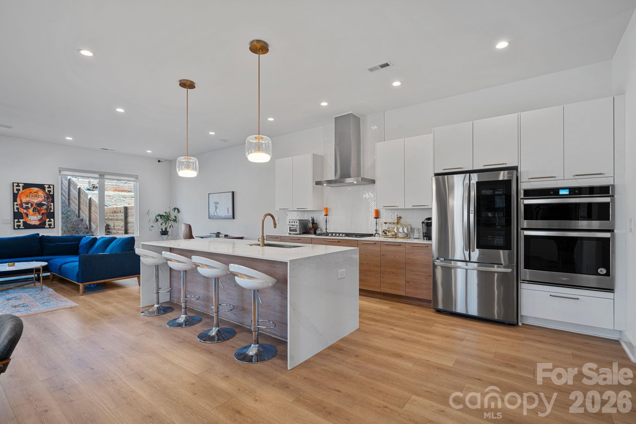 Welcome to City Side West — Where Modern Luxury Meets Urban Living
This isn't just a home. It's a lifestyle upgrade.
Chelsea Builders' meticulously crafted duet home delivers the kind of high-end finishes and thoughtful design you'd expect to pay far more for — and right now, qualified buyers can receive up to $14,250 with no income limits and no repayment required (see flyer for details).
From the moment you step inside, soaring 10-foot ceilings and 8-foot doors set the tone for something special. The open-concept main level flows effortlessly, anchored by a modern gas fireplace and flooded with natural light through expansive windows. Rich solid plank flooring ties it all together with a polished, cohesive look.
The chef's kitchen is built to impress — quartz countertops, a wall oven, flush full-face cabinetry, and a bold, contemporary palette of earth tones with a curated pop of color. Whether you're hosting a dinner party or a casual weeknight in, this kitchen delivers.
Three spacious bedrooms include secondary rooms with elegant tray ceilings and a primary suite designed for true relaxation — complete with a versatile bonus area perfect for a home office, reading nook, or whatever your life demands. A separate laundry room, drop zone, and generous storage mean every inch of this home works as hard as you do.
Outside, enjoy one of the largest duet lots in the community — a spacious, privacy-fenced backyard ready for pets, entertaining, or simply unwinding after a long day. The 1-car garage comes equipped with a 220V EV charger, and smart home integration ties your security system, garage, locks, and cameras into one seamless app.
Practical luxury is built in too: tankless water heater, neutral designer paint tones, and a tucked-away cul-de-sac location for added peace and privacy.
And the location? Authentically urban. A short walk to the Gold Line puts the pulse of the city within easy reach — the hum of the railway, the glow of city lights, the buzz of nearby restaurants and nightlife. This is Charlotte alive and in motion, and it's right outside your door. If you've ever wanted to feel genuinely connected to your city rather than just adjacent to it, this is that home. Minutes from Uptown, with all the energy and convenience that comes with it.
Low-maintenance. High-design. Unapologetically city. Come see it for yourself.