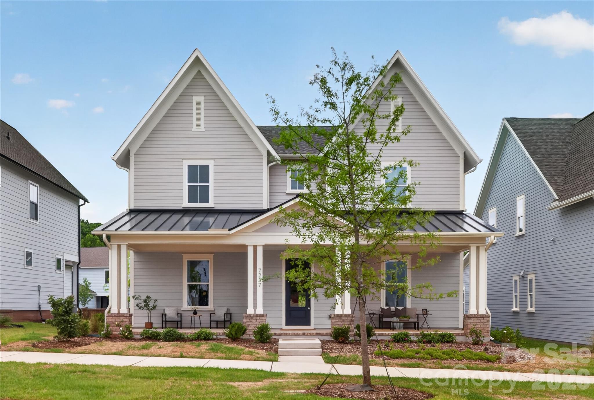 Come fall in love with life at the River District, where the Catawba River and City of Charlotte connect. Surrounded by nature, you'll enjoy hiking, biking and the many planned community amenities the River District has to offer. The Langley Cottage welcomes you with a charming rocking chair front porch. Inside, the open concept floor plan features an inviting kitchen with a large island, perfect for entertaining. The primary suite is conveniently located  on the main level, with three additional bedrooms and a loft upstairs. Plus, working from home is a breeze with the private pocket office! Come discover your new home in the River District Community!