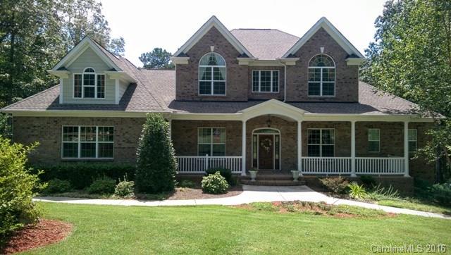 Beautiful brick home located in Fort Mill on almost 3 acre lot offers tons of living space.  5BR/4.5BA, master on main with spa-like bath suite.  Formal dining room, 2 story great room w/coffered ceilings.  Huge kitchen with work island and breakfast room. Second living quarters in finished basement w/2 car garage. Large outdoor area w/ screened porch and deck.  Huge laundry room, attached 3 car garage on main, RV carport, full irrigation, in-home audio on main. Too many details to list.