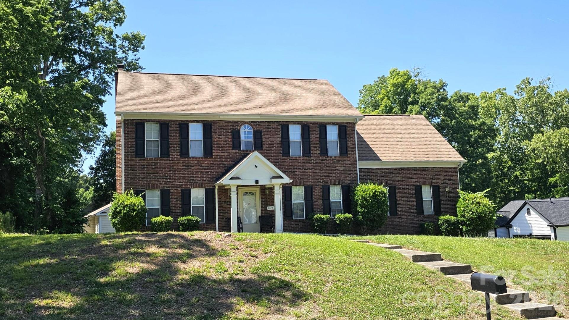 Investment Opportunity! This home is ready for a new chapter and is priced accordingly. It has been loved & gently lived in. Home features a classic front brick facade and a lovely elevated lot that offers great curb appeal. As you step inside, you are greeted by a traditional foyer layout featuring warm parquet wood flooring and a staircase leading to the upper level.

The main level offers excellent functionality for both daily living and entertaining. Cozy up in the generous living room centered around a beautiful brick fireplace, perfect for chilly evenings. The large kitchen comes equipped with a functional island, ample cabinetry, and a bright dining area that provides direct access to the backyard—making indoor-outdoor hosting a breeze. A formal living room is right off the kitchen facing the front of the home. Rounding out the main level you will find a great flex space or office that has doors coming off both the hallway & living room. Upstairs, you'll find comfortable bedroom accommodations with great natural light.

Upstairs you will find the main primary suite & 3 additional bedrooms. The primary suite has wood flooring & huge closet space along with spa-like bath. To the back of the upstairs you will find 3 additional bedrooms sharing a bath, attic access & washer/dryer laundry room.

Outback you have extra carport space with storage & 2 car garage- this home would make a great addition to your portfolio, or as an opportunity to get into a home with 4 bedrooms and without the large price tag. 

Conveniently located in Charlotte with easy access to local amenities, shopping, and dining. Don't miss the opportunity to put your personal touch on this wonderful property!
