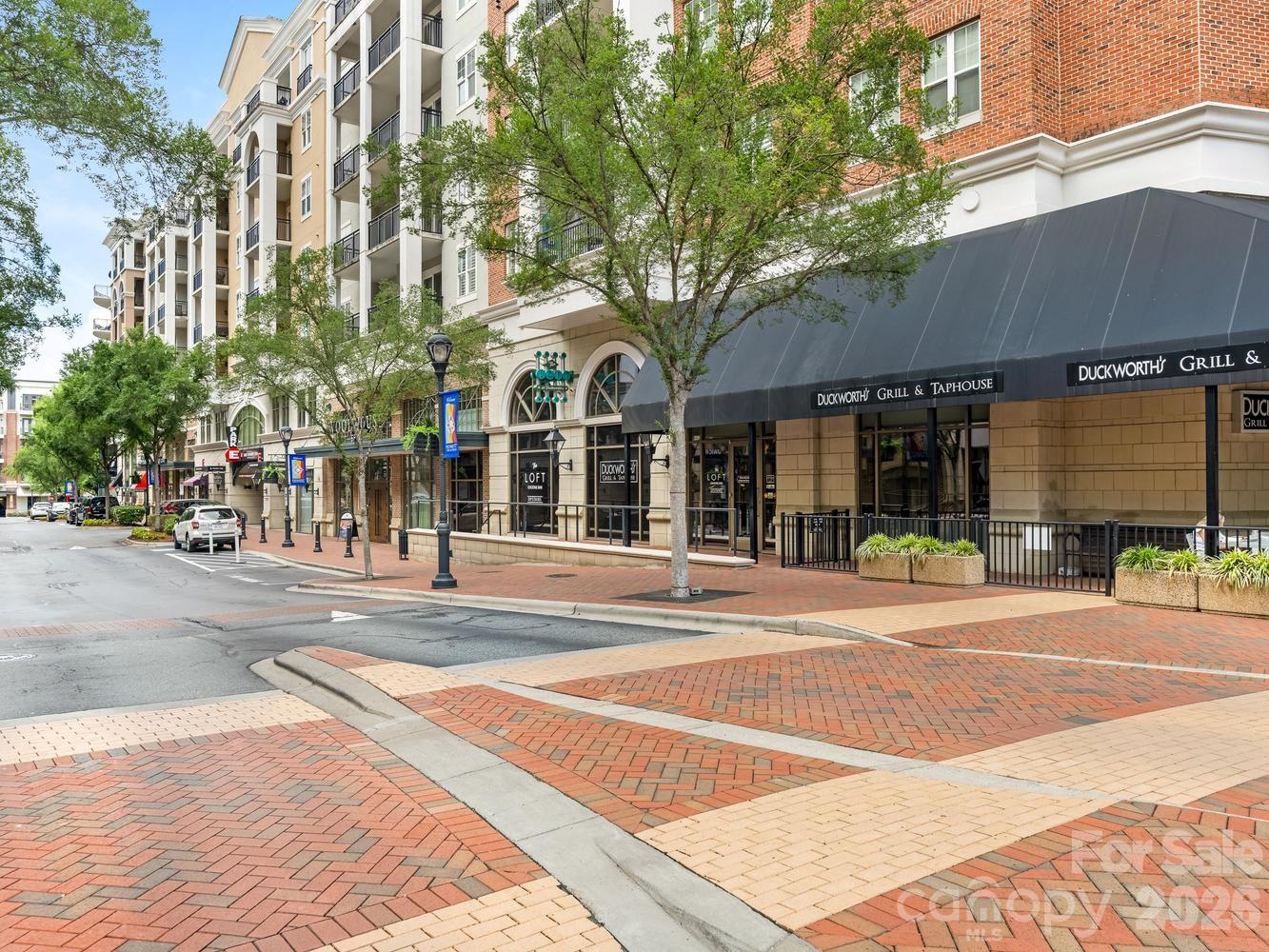 Are you ready to simplify your life? Lovely two bedroom condo near the fountain at Piedmont Row is move-in ready, with 2026 LVP flooring through living area and bedrooms, 2026 appliances in the kitchen, 2026 water heater and 2020 heat pump. 4th floor location gets great light through the double-wide balcony accessible from living room and secondary bedroom. This floor plan features an office niche next to the dining area with a built-in desk surface. Great storage in the pantry closet in the kitchen and linen closet in the hall bath. Unit comes with two side-by-side assigned gated parking spaces on the same level, with 7 floors of guest parking in the building. Complex is home to fabulous restaurants, dry cleaner, personal care spaces and fitness club and is steps away from Southpark Mall and even more restaurants. The free Southpark Skipper on-demand driver service makes getting around this vibrant community a breeze--everything you need is just outside your door!