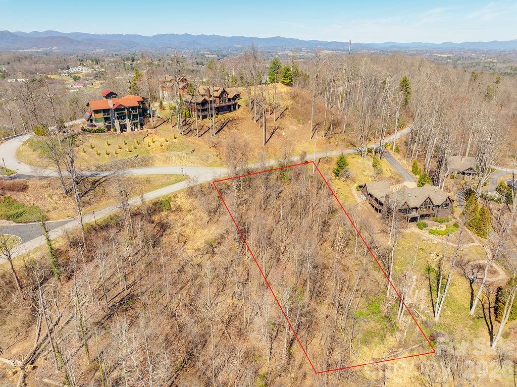 Welcome to Crest Mountain! A gated, eco-friendly community, known for its mountain views, upscale modern homes, and convenience -- all with a low HOA fee with a coveted feel! Experience the best of both worlds with modern amenities like city water and sewer available, paved roads, underground utilities (including fiber-optic internet), and picturesque hiking trails. This lot quite literally has it all. Ready to build? This .75 acre lot features a ridgetop setting with long range mountain views ready for your dream new-build. All within minutes of Downtown and minutes to New Leicester Highway or North Asheville amenities - without the city taxes. Schedule a visit today!