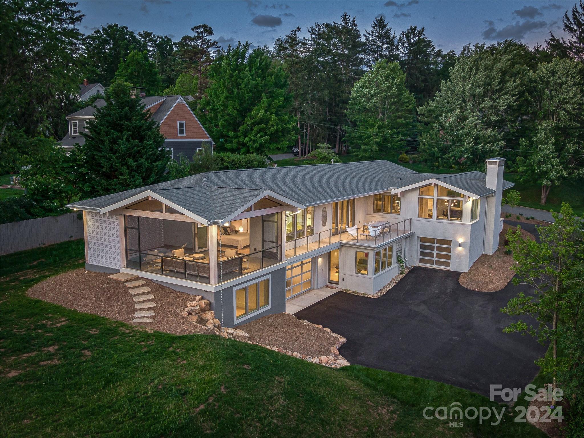 Welcome to an unparalleled fusion of modern luxury and timeless sophistication in this meticulously redesigned mid-century masterpiece by renowned local architect, Mark Sinsky. This superb North Asheville residence is named ‘The Wembley’ after the famous Parker House in Palm Springs. Enjoy refined elegance directly overlooking the Country Club of Asheville golf course. Clean lines, custom milled Radiata pine siding, high ceilings, and an abundance of natural light create a tone of serenity and grace. The gourmet kitchen features top-of-the-line appliances, custom cabinetry, and marble countertops and the primary suite has golf course views plus a private screened porch complete with built-in lap pool/hot tub and plenty of space to relax. The terrace level offers fabulous open space perfect for a home theatre/game room plus separate guest suite makes an ideal home office. With unparalleled craftsmanship, this architectural gem represents the pinnacle of California living in Asheville.