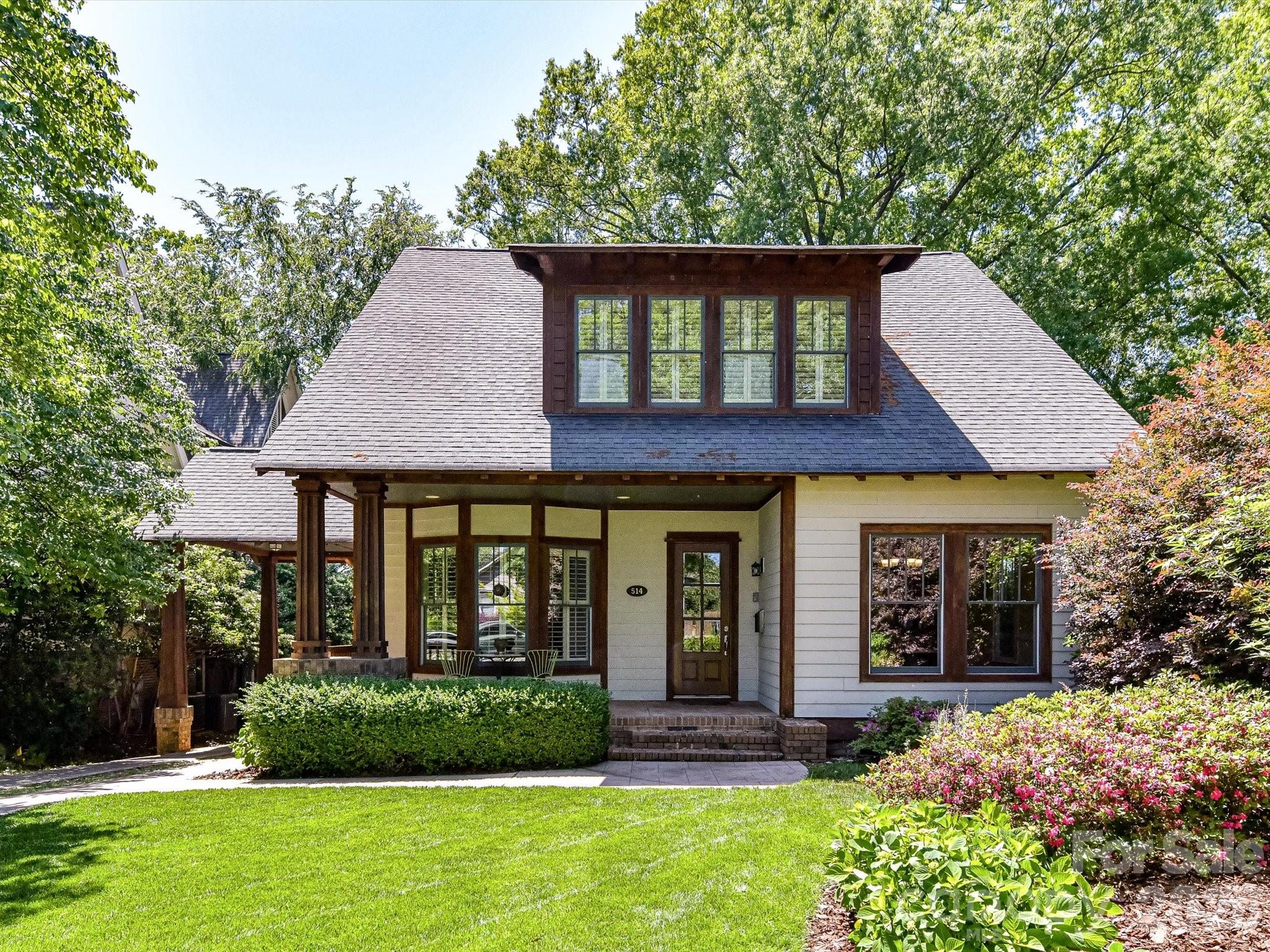 Welcome to a stunning and unique Craftsman-style home perched atop one of Dilworth’s most desirable locations. Set upon Magnolia Hill, this 4-bedroom, 3.5-bath residence offers 3,254 square feet of elegant living space, thoughtful design, and modern convenience – all just five minutes from Uptown Charlotte. ***** Step inside to soaring 10-foot ceilings and elegant crown molding throughout the first floor with 9-foot ceilings upstairs. The home’s open concept flows seamlessly from the well-appointed kitchen that boasts a massive island with seating for 8+, premium Wolf appliances, gas burners with a griddle, and a touchless faucet. From the kitchen, enjoy an uninterrupted view across the living area and through tall glass French doors leading to the screened-in back porch. The porch overlooks a cozy patio and green space with fenced-in and natural privacy. ***** The home includes two primary suites, one on each floor, and each with its own spacious bathroom, dual sinks, separate walk-in shower, tub and enormous walk-in closets. The downstairs suite also features a luxurious Jacuzzi tub. Two additional bedrooms upstairs share a full bath with dual sinks. The laundry room and linen closet are conveniently located upstairs. ***** Additional highlights include: * Fresh paint and new hypoallergenic carpet throughout * Smart home features including Alexa-enabled lighting, smart thermostats for both HVAC zones, bathroom lights and fan controls, smart gate and smart garage door system, etc. * Hardwood floors throughout most of the main level, with cozy carpet in the downstairs primary suite, upstairs hallway and bedrooms * Concealed in-wall wiring for sleek, wire-free TV setup in living room and upstairs primary * A downstairs versatile flex space—ideal for a music room, home office, or playroom * Extra shelved storage space tucked under the stairs and accessible from the kitchen * A fully fenced backyard with electric gate; irrigation system in both front and back yards * Detached garage with smart automatic door and freezer; Level 2 EV charger installed * Widened parking pad fits multiple vehicles and ensures easy exits – a Dilworth luxury * Carport and side entryway that leads directly to a roomy, 10-foot-high kitchen pantry * Generous “walk-in” crawl space beneath the house for expansive storage in addition to the upstairs attic spaces ***** Located in the highly desirable Dilworth community, this home offers quick access to some of Charlotte’s best restaurants, retail, parks and community/cultural events. In addition, you are only blocks away from South End’s unique urban energy, light rail access and rail trail recreation. ***** Don’t miss the opportunity to own this hilltop gem in a truly unbeatable location.