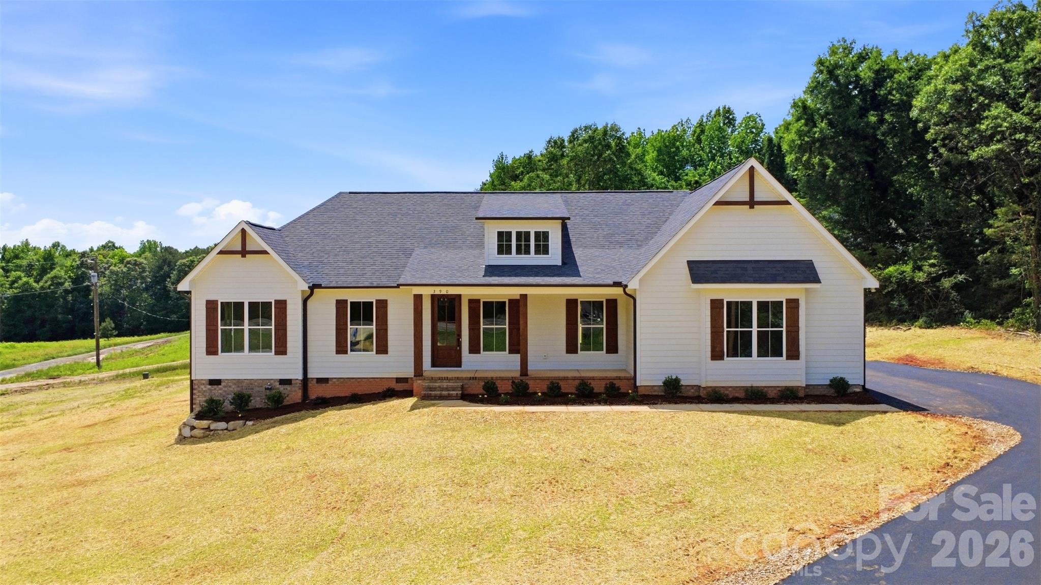 Introducing the Westcott by Summit Building Group, one of Summit’s newest and most versatile floor plans, thoughtfully designed with flexibility, functionality, and quality craftsmanship in mind. Known for building throughout Stanly, Cabarrus, and Union Counties, Summit continues to deliver homes that blend modern finishes with practical everyday living.

This 5-bedroom, 3 full bath home offers a unique and adaptable layout ideal for a variety of lifestyles, including multi-generational living, guest accommodations, or creating additional private living space. One wing of the home features its own bedroom, full bath, study, secondary living/dining area, dedicated laundry space, and separate exterior entrance, creating a flexible setup with endless possibilities and added privacy for guests or extended living arrangements.

The exterior showcases durable fiber cement siding along with a welcoming covered front porch accented by wood posts and a stunning solid wood 8-foot front door, creating a warm and inviting first impression. Inside, you’ll immediately notice the vaulted living room centered around a striking black shiplap electric fireplace. The kitchen has been upgraded with quartz countertops, upgraded cabinetry, and a vent hood, combining style and functionality for everyday living and entertaining alike.

Additional highlights include tray ceilings in the primary suite, wood shelving in the primary closet, and a beautifully finished ensuite bath featuring a tiled walk-in shower with glass enclosure. Summit’s attention to detail and craftsmanship can be felt throughout the home.

Situated on just over an acre with no HOA and only minor restrictive covenants, this property offers the perfect balance of privacy and freedom while still maintaining convenient access to everyday amenities. Located just minutes from downtown Stanfield and conveniently positioned near NC Highway 200 and Highway 601, you can enjoy peaceful country living without sacrificing accessibility.

Coming soon and expected to hit the market early next week — don’t miss the opportunity to preview one of Summit Building Group’s newest floor plans before it officially launches.