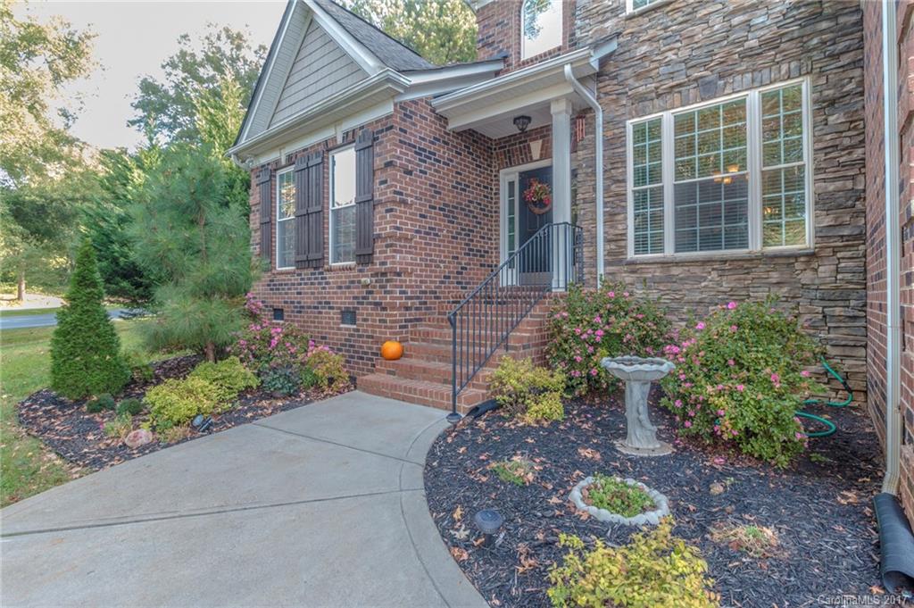 Gorgeous 2-story, full brick home in desirable Regent Park. Home features open floor plan w/ main floor master suite w/ trey ceilings, stunning kitchen w/ granite counters, SS appliances, wine-fridge, hardwoods throughout downstairs & loft, custom moldings throughout. Spacious eat-in kitchen opens to private deck w/ a beautiful wooded view. Guest bedrooms feature roomy walk-in closets. Community offers a playground, pool and tennis courts! Located in the award-winning Fort Mill school district!