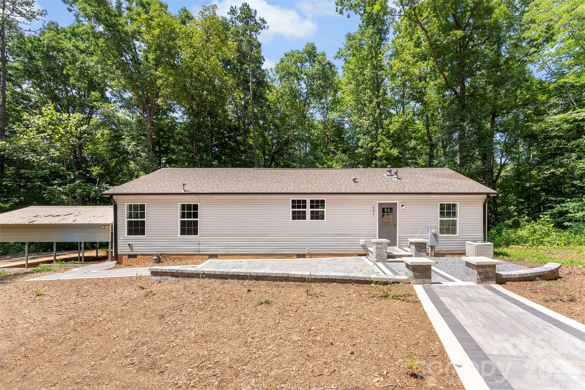 Escape to your own private retreat! Nestled on **4.27 acres of wooded privacy**, this beautifully updated modular home offers the perfect blend of peaceful country living and modern style. A long, private driveway welcomes you home, leading to stunning hardscape landscaping patio that creates exceptional curb appeal.
  Inside, you'll find a home that shows like new, featuring fresh paint throughout, luxury vinyl plank flooring, charming farmhouse accents, a spacious kitchen with a center island, and all kitchen appliances included. The primary suite is designed for comfort with double vanities and a large walk-in shower, while the secondary bath also features double sinks for added convenience. The washer and dryer will remain, making this home truly move-in ready.
  Outside, there's plenty of room for work, hobbies, and storage with a double freestanding carport and an impressive **24' x 25' wired workshop** complete with **two 12-foot garage doors**—ideal for large trucks, equipment, recreational vehicles, or a serious workshop.

If you're searching for privacy, functionality, and a home that's been thoughtfully updated from top to bottom, this property is a must-see!