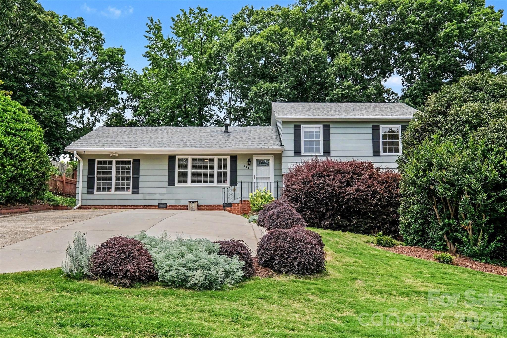 Welcome to 1030 McLaughlin Drive in Charlotte.  A well-maintained split-level home that has flexible living space and a backyard built for relaxing. This 4-bedroom, 2-bath home features hardwood floors throughout much of the main living areas, tile flooring in the kitchen, and a comfortable carpeted lower-level family room. The interior has been freshly painted, and the kitchen has been updated with new cabinet hardware for a clean, refreshed feel.
The main level offers a functional layout with inviting living spaces, while the lower level provides additional room for entertaining, movie nights, hobbies, or everyday hangout space. The home also includes a versatile flex room with a working sink and cabinet storage; perfect for a home office, study, creative space, craft room, small bar setup, or additional storage area.  Outside, the recently landscaped front yard adds curb appeal, while the backyard offers a peaceful setting designed for relaxation. Two storage sheds provide extra room for tools, equipment, seasonal items, or weekend projects.  Located near restaurants, coffee shops, brewery spaces, and everyday conveniences, this home gives you a practical layout with the lifestyle access many Charlotte buyers are looking for. With 4 bedrooms, 2 full bathrooms, multiple living areas, and flexible space throughout, 1030 McLaughlin Drive offers comfort, function, and room to make it your own.