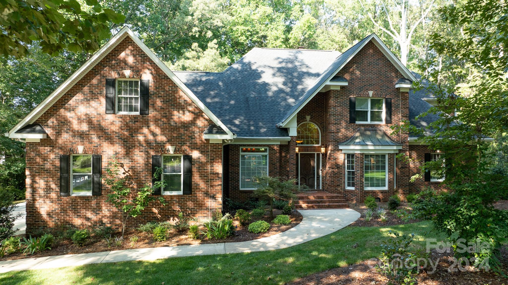 Welcome to this beautifully maintained home in one of Rock Hill's most desirable neighborhoods.  This community offers a clubhouse and pool, 4 lakes, tennis court and is golf cart friendly.  So many beautiful custom features including heavy molding and gorgeous built ins.  The living room has sky lights and windows across the back of the home, that looks out onto a 310 square foot beautiful brick paved terrace that has a gas fire pit and a gas fireplace.  The primary suite, an additional bedroom and two and a half baths on the main level.  The laundry room was designed with functionality in mind - standalone sink and built in cabinets with countertop.  The upper level provides grand space where there are three additional bedrooms, two full baths and a bonus room with wet bar.  The catwalk is spacious and can serve as a loft.  An encapsulated HVAC duct system, an air cleaner system and an HVAC system that's only a couple years old is some of the added features to this home.