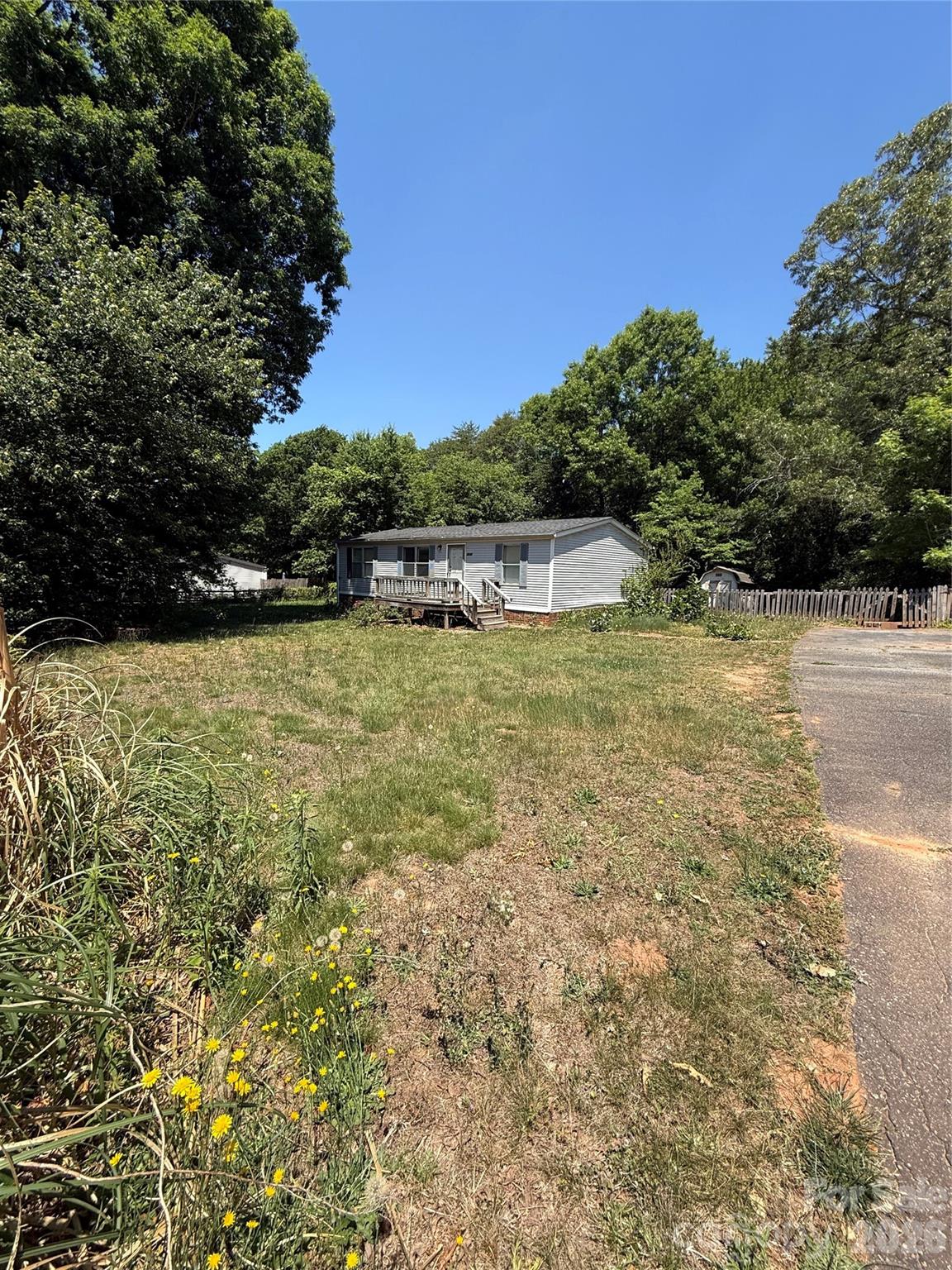 Investor special situated on a flat half-acre lot with mature privacy trees. 3 bed, 2 bath with plenty of potential for renovation, rental income, or a fix-and-flip opportunity. Peaceful setting with room to expand, garden, or create your ideal outdoor space. Great opportunity for investors or buyers looking to add value! Enjoy no city taxes and low Lincoln County taxes! Half mile from HWY 16 for easy commute to Charlotte, Hickory, or Huntersville. Four miles HWY 150 for plenty of public boat access on beautiful Lake Norman! Seller has never occupied property; therefore, disclosure information is limited. Property is sold as-is in current condition. Personal property in shed included.  Manufactured home was converted to real property in 2008. Square footage from tax records.