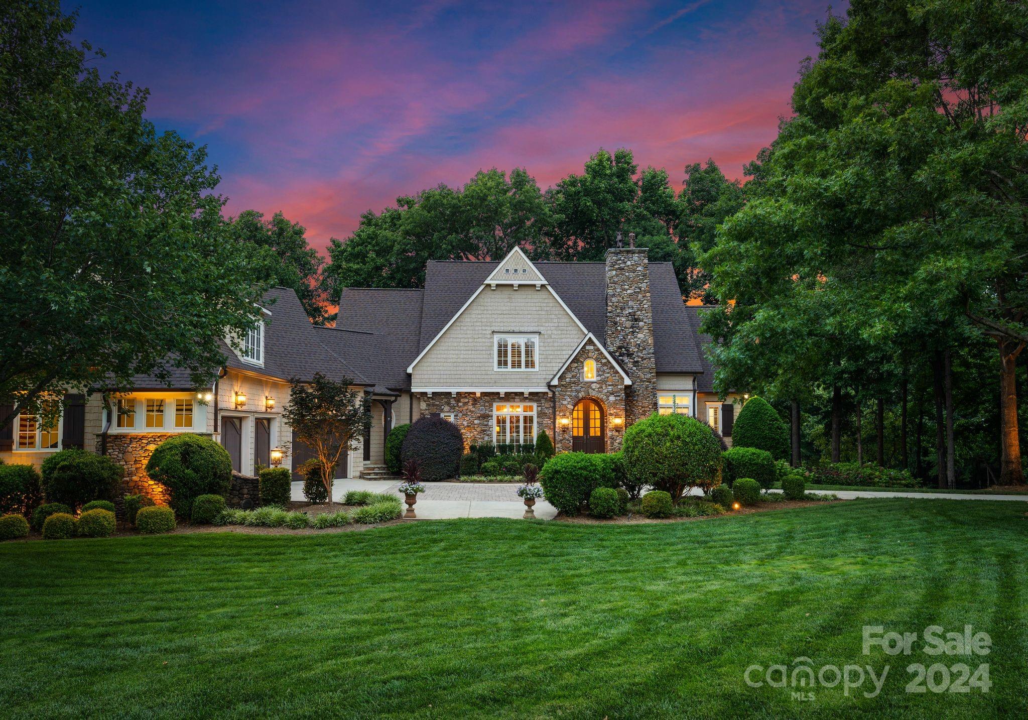 Experience the ultimate in waterfront living on Lightship Drive in The Point! Ideally situated in a beautiful cove with both big water views & views of the 13th hole at Trump National Golf Club. This quality Kingswood home has an ideal layout for comfortable everyday living. Enjoy the Lake life with a screened-in porch, stone balcony, covered lake level patio leading to an outdoor fireplace, saltwater pool & spa with a flagstone deck & dock with sunset views! The main level layout is open with a formal dining room, study with gas fireplace, great room with gas fireplace & built-ins. The chef’s kitchen has recently updated appliances, beautiful white cabinets & expansive island. The main level primary suite has access to the screened-in porch & great views. On the upper level you will find 3 bedrooms with ensuite baths, a theater room & two bonus spaces. The lake level is ideal for entertaining with an open flexible layout & warm wood bar and a bedroom. The best of lake living awaits!