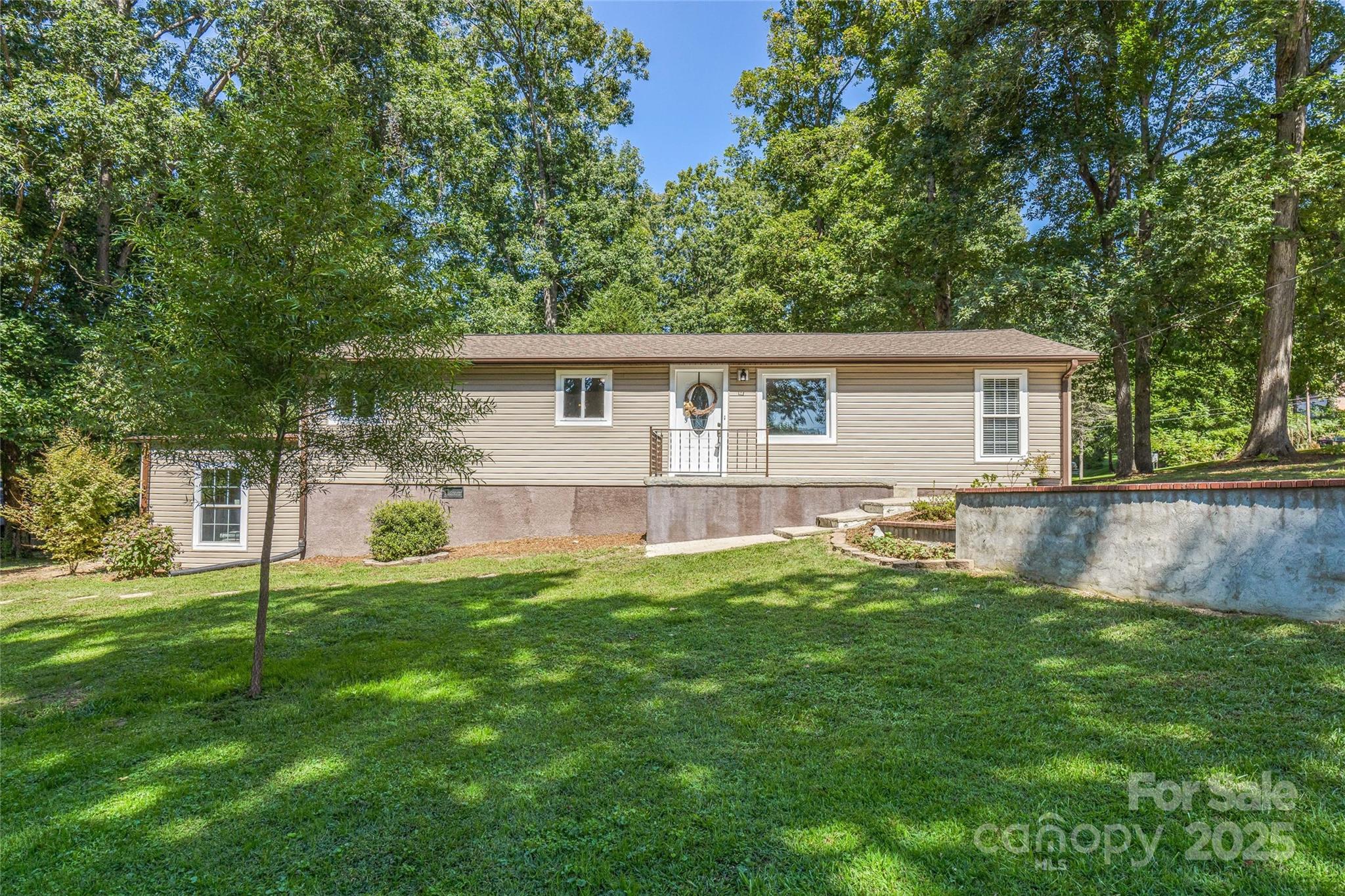Welcome to this inviting and charming 3-bedroom, 1.5-bath ranch-style home nestled in the heart of Hendersonville. Set on a beautiful lot with mature trees and plenty of green space, this property offers both privacy and convenience.
Inside, you’ll find an open living area filled with natural light, new floors, and large windows that create a warm and welcoming atmosphere. The updated kitchen features stainless steel appliances, newer countertops, and modern backsplash details, making it both functional and stylish.
The bedrooms, offer comfort and flexibility, while the full and half baths provide practicality for family living or guests. Additional highlights include fresh interior finishes, versatile bonus spaces, and ample storage options.
Outside, the property includes a level yard perfect for gardening, play, or entertaining. A detached workshop/storage building adds even more utility. Enjoy the peaceful setting while being just minutes to downtown Hendersonville, local schools, shopping, and dining.