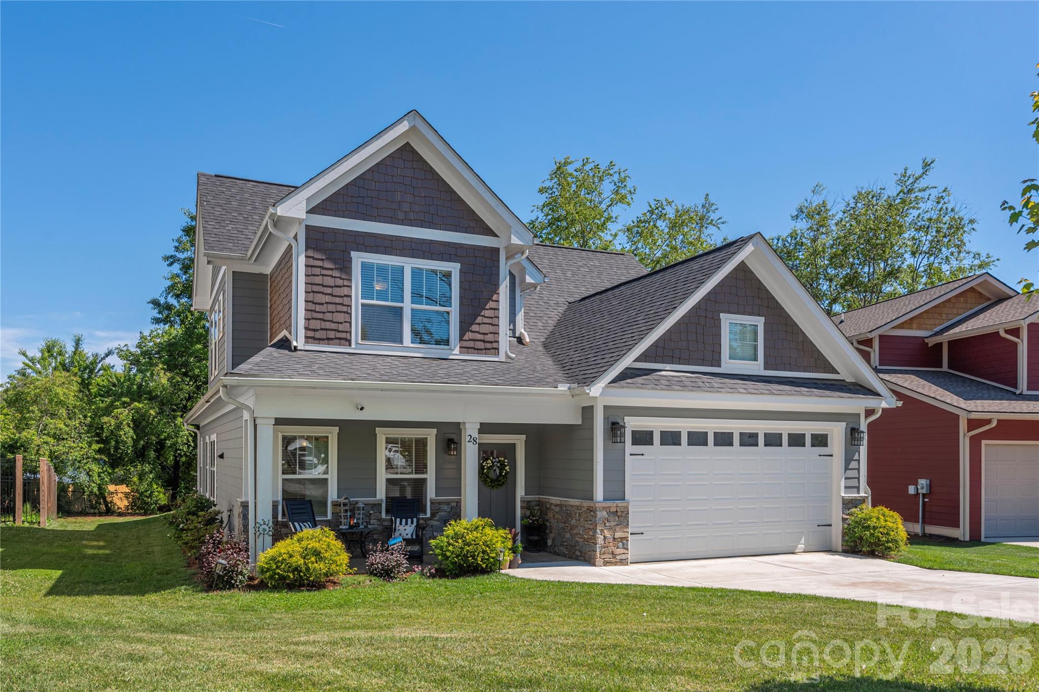 Almost new and beautifully designed for both everyday comfort and effortless entertaining, this bright and open home in desirable South Asheville’s Legacy Park offers the perfect blend of modern style, flexible living, and convenience. Tucked away in a cul-de-sac and just walking distance to Jake Rusher Park, this thoughtfully designed two-story home features zoned HVAC and quality finishes throughout.
The inviting open-concept main level is filled with natural light and showcases luxury vinyl plank flooring, multi-level crown molding, trey ceilings, and a spacious living room centered around a cozy gas fireplace. The kitchen was designed with both function and gathering in mind, offering a large island with bar seating, 42-inch cabinetry, granite countertops, stainless appliances, and a generous walk in pantry.
The main-level primary suite provides comfort and privacy with a custom walk-in closet and well-appointed bath with double vanity and walk in shower with seamless glass doors. A spacious laundry room and convenient half bath complete the main level. Upstairs offers three additional bedrooms, full bath, and exceptional floored attic storage tucked into the upper-level eaves — a rare and valuable feature in newer construction.
Enjoy outdoor living from the covered front porch or rear patio, with the exterior wrapped in attractive fiber cement siding with stone accents. Additional highlights include a tankless hot water heater, attached oversized 2-car garage, functional floor plan, and excellent use of space throughout.
With its bright interior, flexible layout, modern finishes, and unbeatable South Asheville location close to parks, shopping, dining, and everyday conveniences, this home truly offers the complete package!