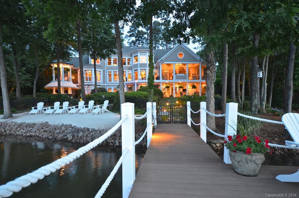 Privacy galore in THE POINT VILLAGE.  Feel like you're in a garden oasis year round. An "at home" feeling the moment you walk thru the front door.  Open floor plan with spacious hearth room off kitchen, screened porch with FP & Grilling area. Cozy sunroom, Master suite has fireplace, his and her closets, private outside terrace. Lk. Level Pub, Media & Wine Cellar. Pool, Spa, Sandy beach & More!