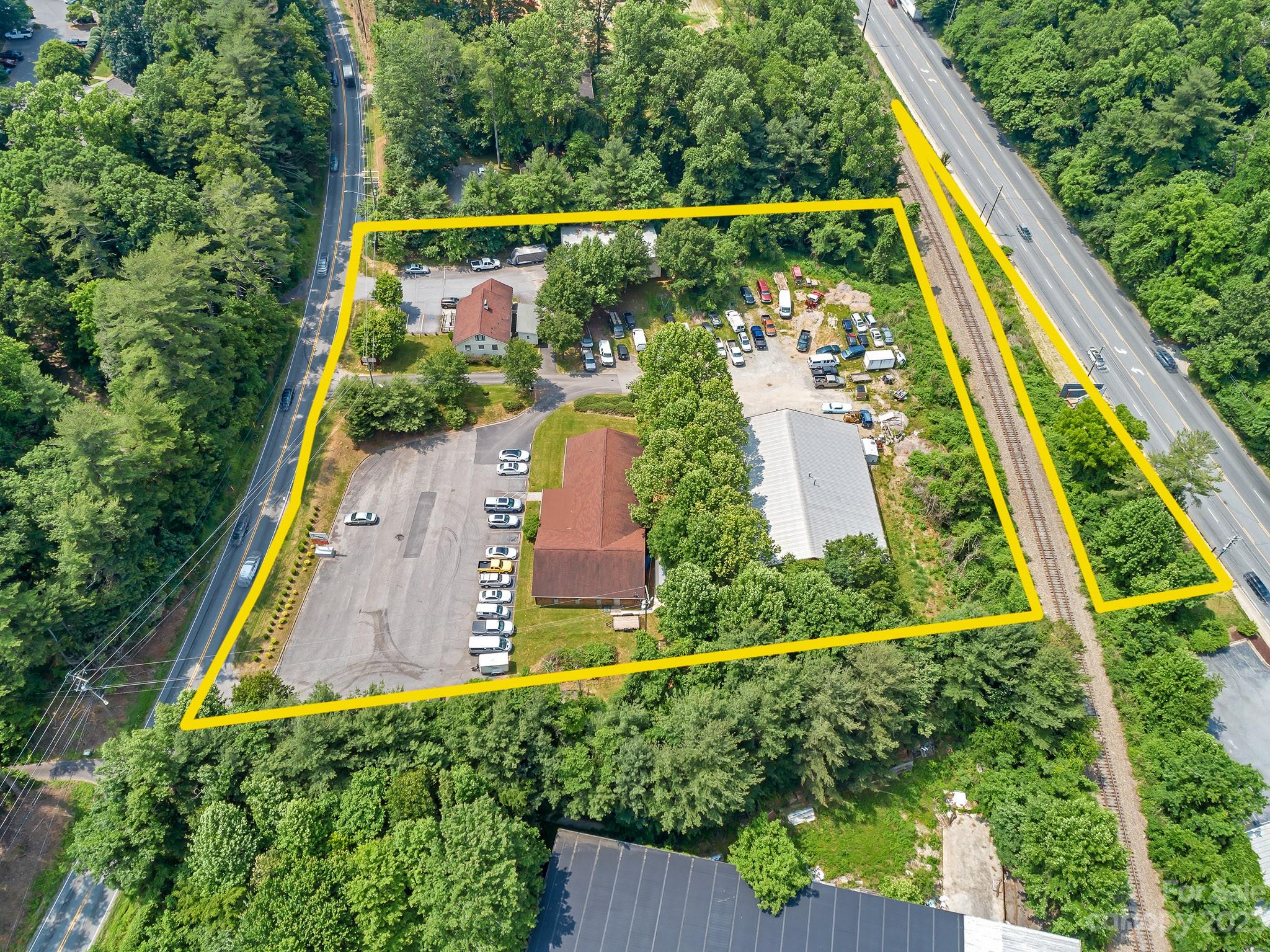 COMMERCIAL COMPLEX INVESTMENT OPPORTUNITY with 384 ft of frontage on Sweeten Creek Road and 330 ft of frontage on Hendersonville Road. Complex includes: 4,600+ sqft office building with multiple offices, large conference room, break room, restrooms, and plenty of storage, 8,300 sqft heated warehouse currently being used as an autp shop, 2,431 sqft unheated warehouse, and 1,433 sqft single family home. Complex also includes 2-sided billboard facing high traffic zone on Hendersonville Road. Multiple paved parking lots with 80+ spaces and additional gravel lot across from auto shop. Large sign board fronts on Sweeten Creek Road and property has multiple points of access making it an ideal multi-tenant configuration. Contact your Realtor for a copy of the Listing Brochure with further information. Please do not disturb tenants.