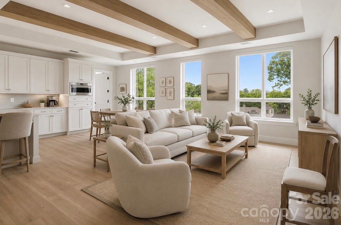 A truly exceptional and rarely available offering in Eastover, this expansive Estate condo delivers over 4,500 square feet of elevated living defined by privacy, scale, and understated luxury. Thoughtfully designed with 4 bedrooms, 4 full baths, and a powder room, each bedroom is a private ensuite, creating an ideal balance of comfort and separation, complemented by generous walk-in closets, abundant storage throughout, a statement fireplace, and two terraces with sweeping Uptown views. The family room is accented by striking wood beams, adding warmth and architectural character, while soaring ceilings and walls of oversized windows fill the home with natural light and enhance its refined, private feel. One of the terraces is a covered outdoor retreat with a fireplace, creating an inviting extension of the living space year-round. The kitchen is a standout, beautifully appointed with custom cabinetry, Sub-Zero refrigeration, Wolf cooking appliances, and Cove dishwashing—perfectly blending form and function. The owner’s suite is a true retreat, offering a spa-inspired bath, heated floor, steam shower, freestanding tub and expansive closet space. Residents enjoy a curated, full-service lifestyle with concierge service, a secure building, and access to elegant amenities including a club room, fitness center, and a rooftop terrace with fire pit, outdoor kitchen, and sophisticated gathering spaces. With deeded parking spaces included, this pet-friendly residence represents a rare opportunity to own a distinctive, high-design home in one of Charlotte’s most prestigious and private enclaves.